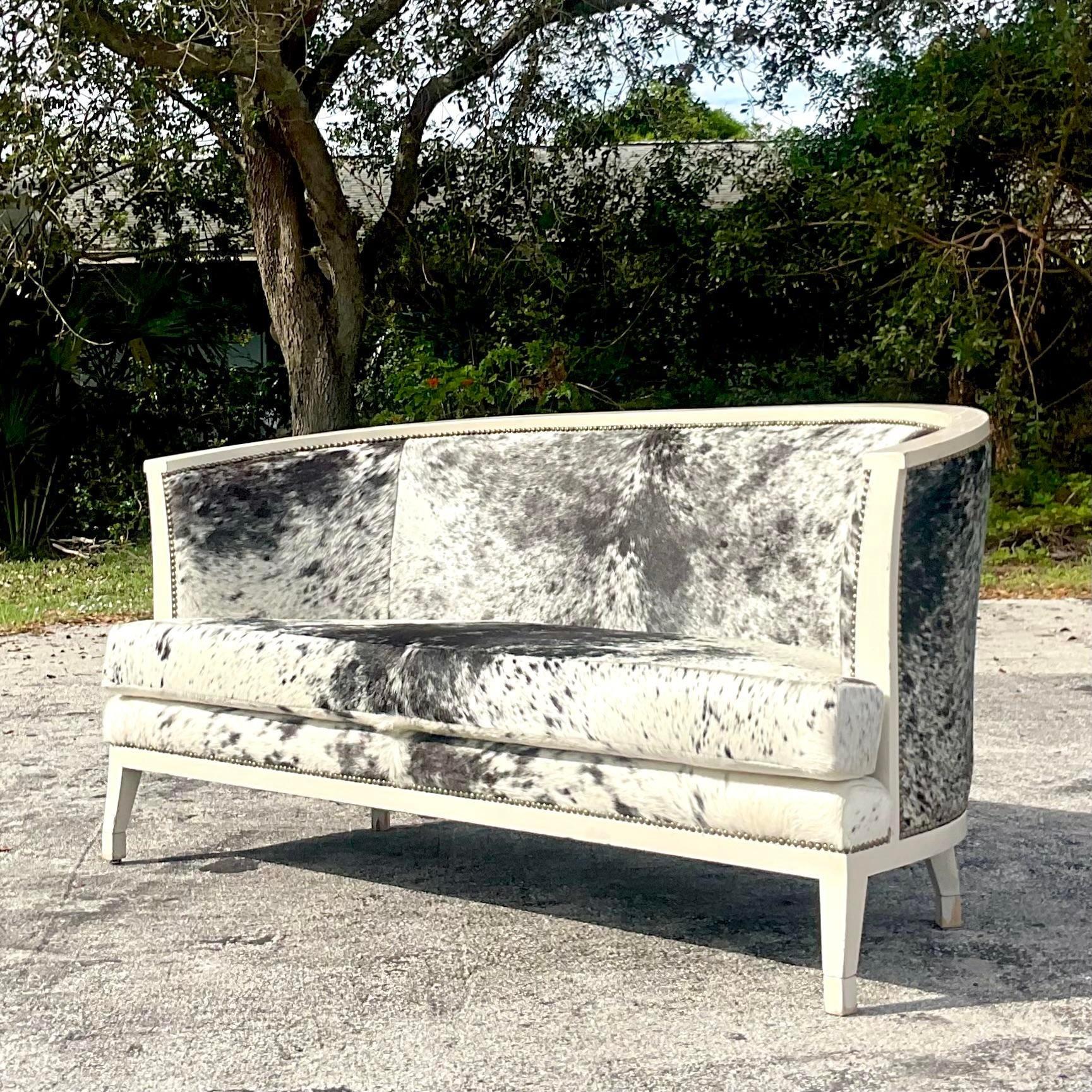 A fabulous vintage Coastal curved sofa. A gorgeous chair moon shape with chic Pony hide upholstery. Rest on a lacquered ivory frame with a silver nailhead trim. Purchased from the Miami estate of LeBron James. 