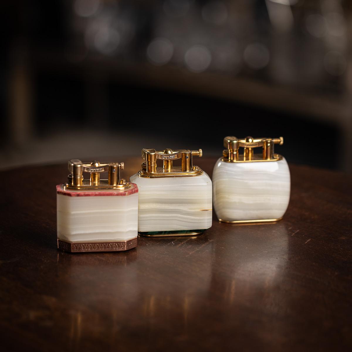 A wonderful 20th Century Dunhill table lighter, crafted with an Italian white onyx body and fitted with a gold plated mechanism. Stamped with the classic Dunhill name on the gold plated side and underneath on the base. Made in England. 

Beyond