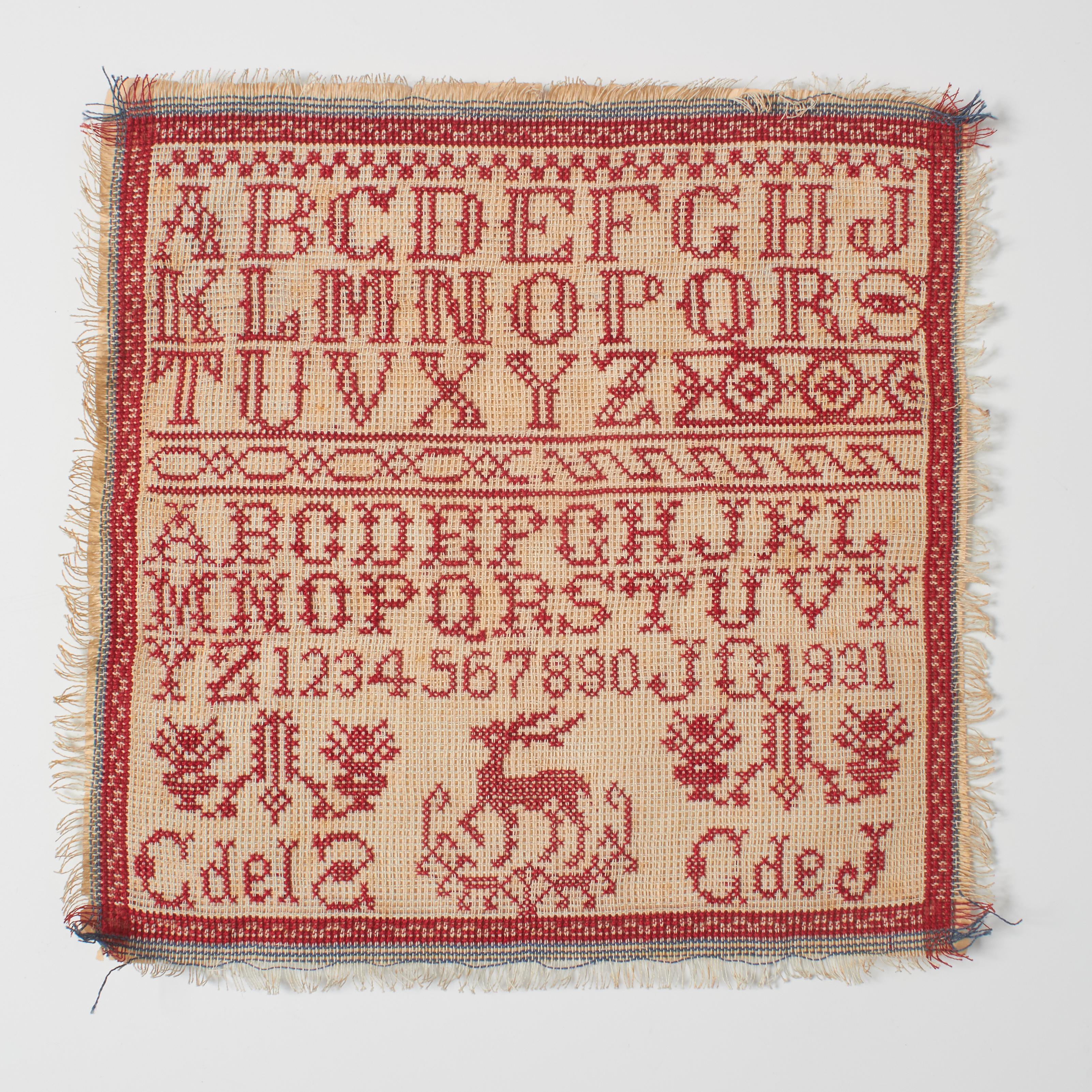 Dive into the timeless allure of our vintage cross-stitch sampler from the early 20th century. This unique piece showcases a classic red-on-white design featuring meticulously crafted letters of the alphabet, numbers, and a graceful border that adds