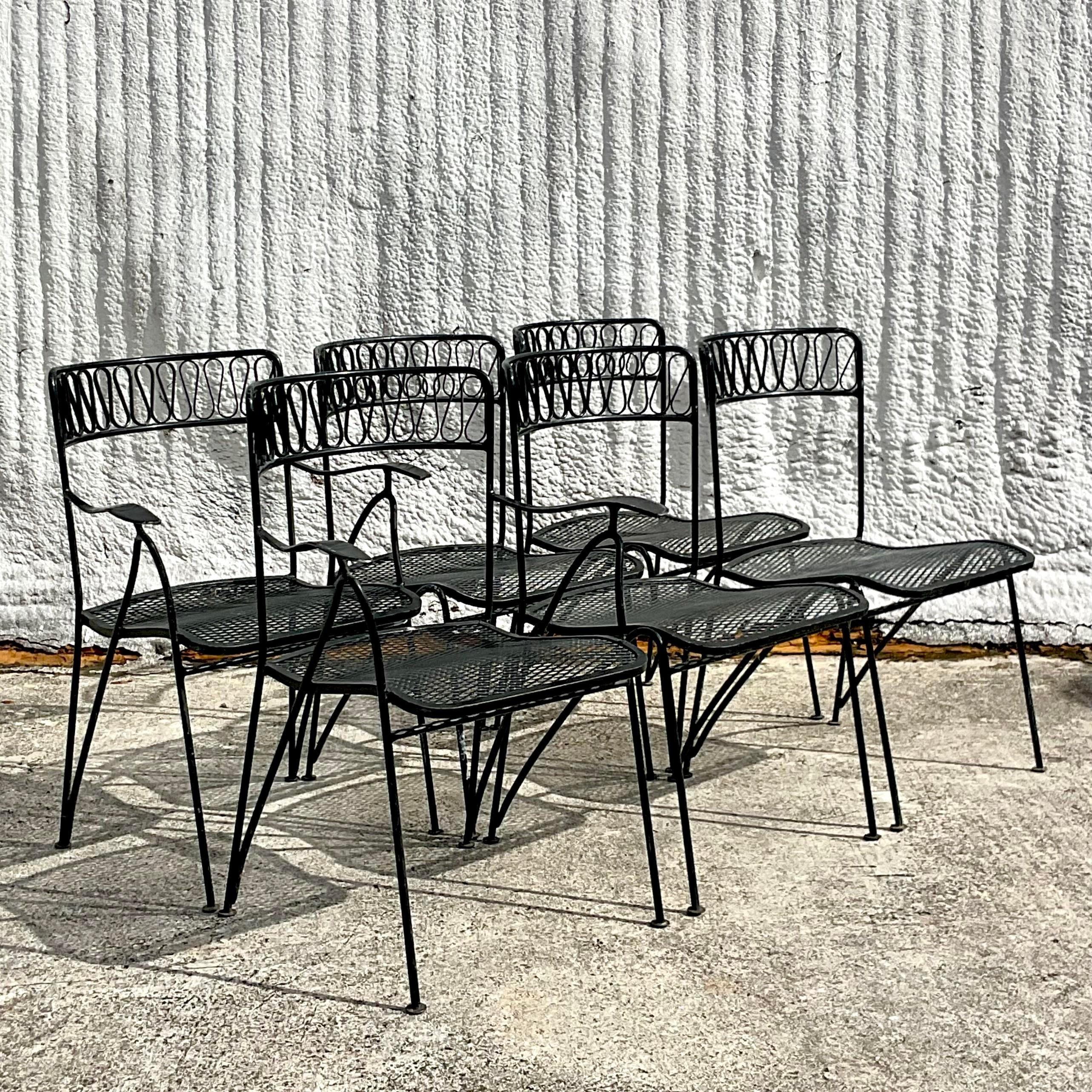 A fabulous vintage MCM outdoor dining table. Made by the iconic Salterini group. Unmarked. The coveted ribbon design in a classic round shape. 47 inch round glass top, but easily can take a larger piece of glass if needed. Coordinating chairs also