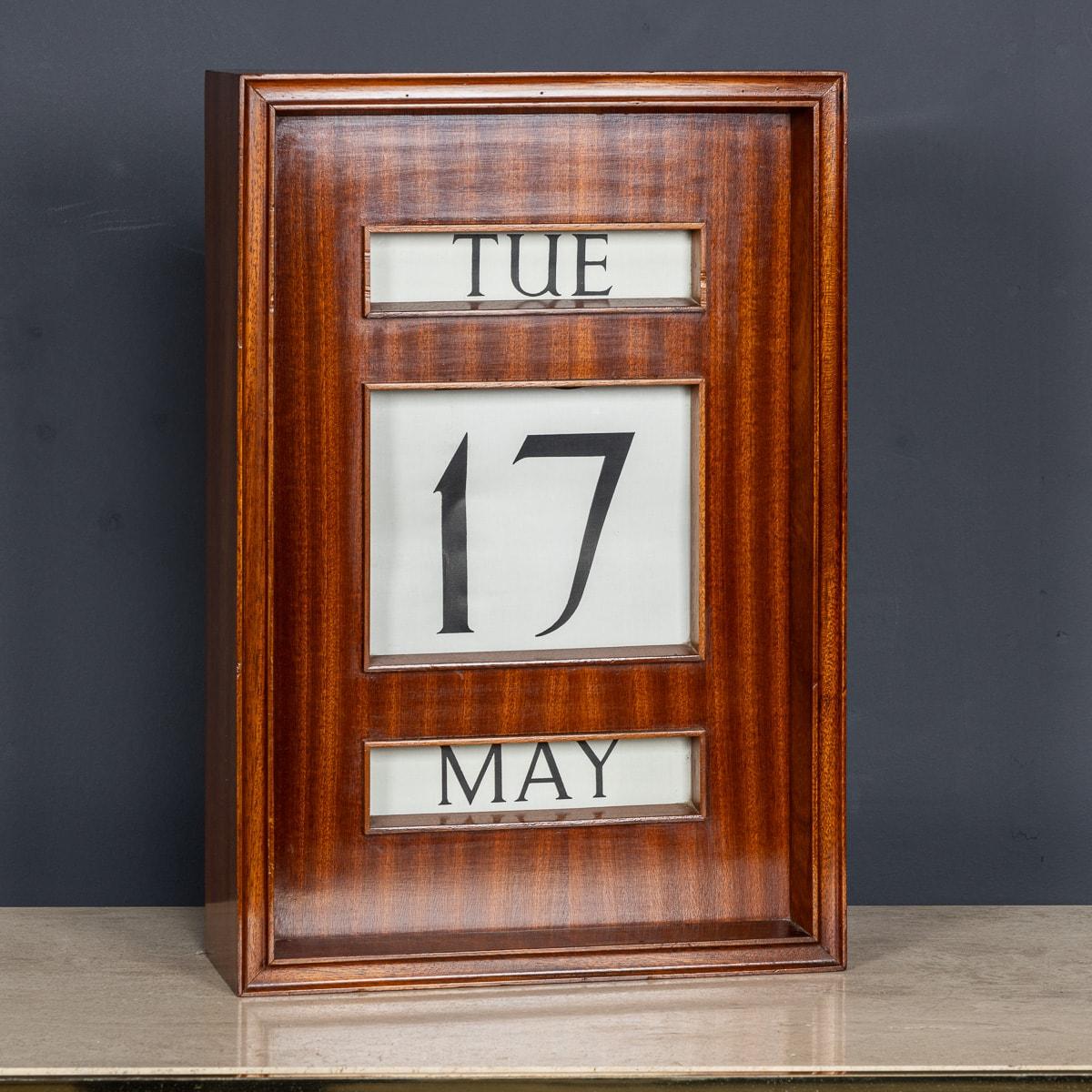 Vintage 20th Century perpetual desk calendar, made from striped wood. There is a small hinged door to one side revealing six knobs, these are used to move forward and rewind the day, date and month behind three glazed apertures. On the rear, two