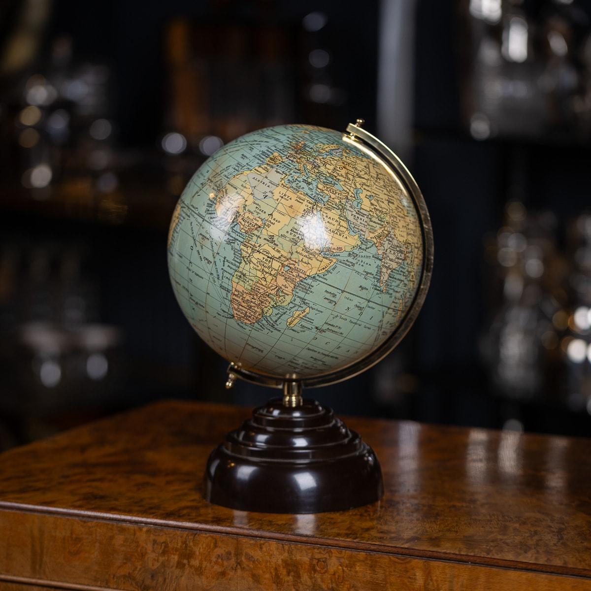 A superb 20th Century terrestrial globe made by Geographica of Fleet Street, London. Set on a brass axis, mounted on a black moulded base. Vintage globes serve as captivating snapshots of history, where geopolitical borders ebb and flow like tides