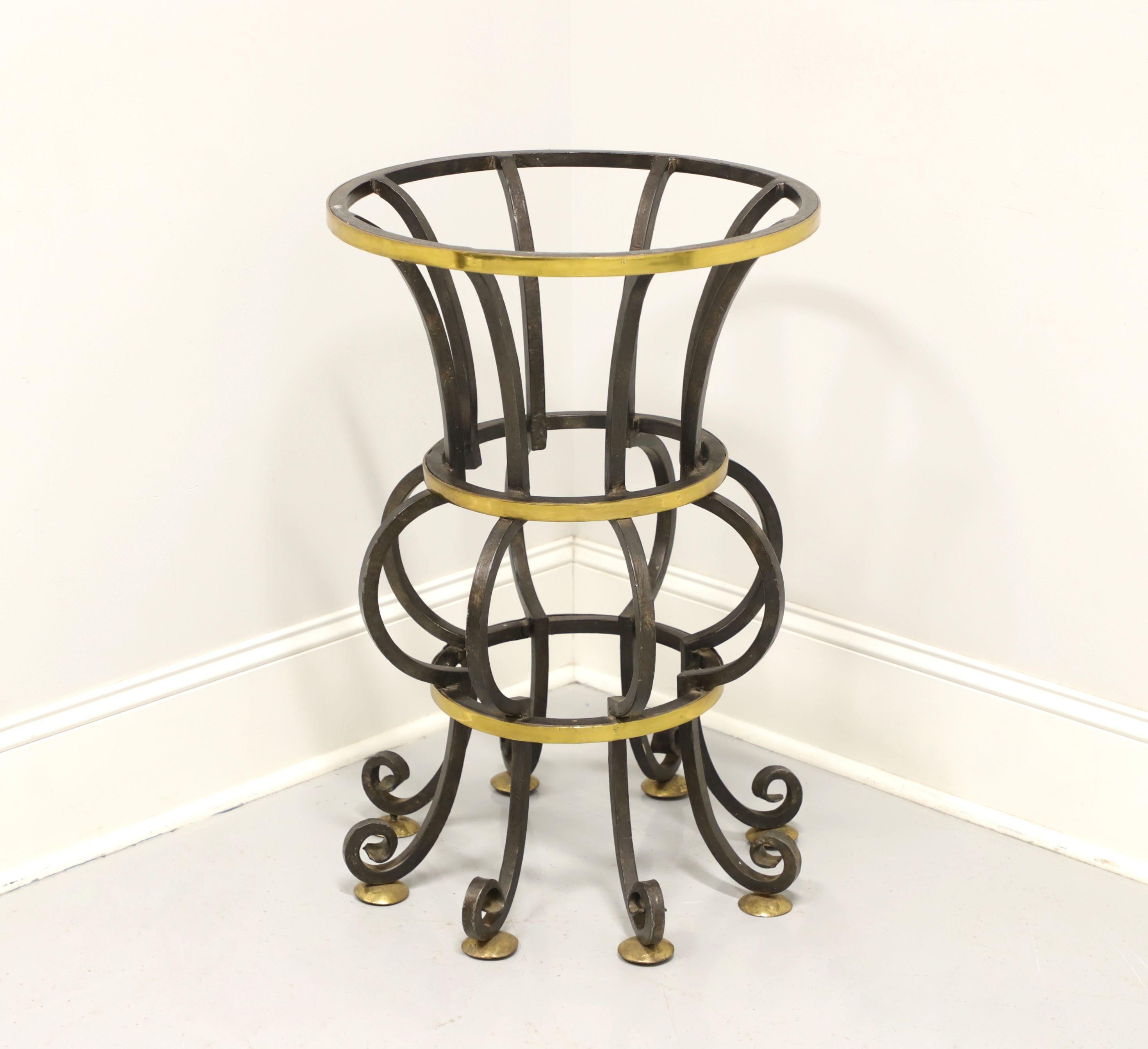 A Contemporary style table base for a glass top, unbranded. Wrought iron with deocrative brass accents in an urn like design. Ready for your style of round glass table top. Likely made in the USA, in the mid 20th Century.

Measures: 20.25 W 20.25