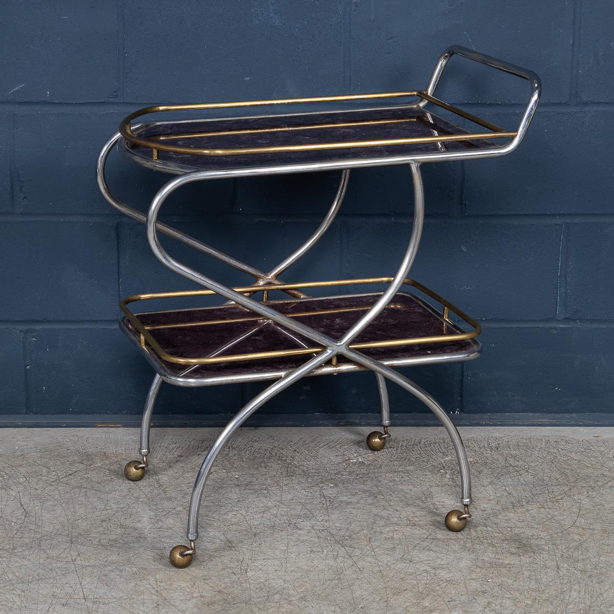 This striking Italian drinks trolley from circa 1980 combines a steel and brass frame with sumptuous purple, marble-effect glass shelves, creating a captivating interplay of materials and colors. Resting on smooth-rolling casters, it offers both
