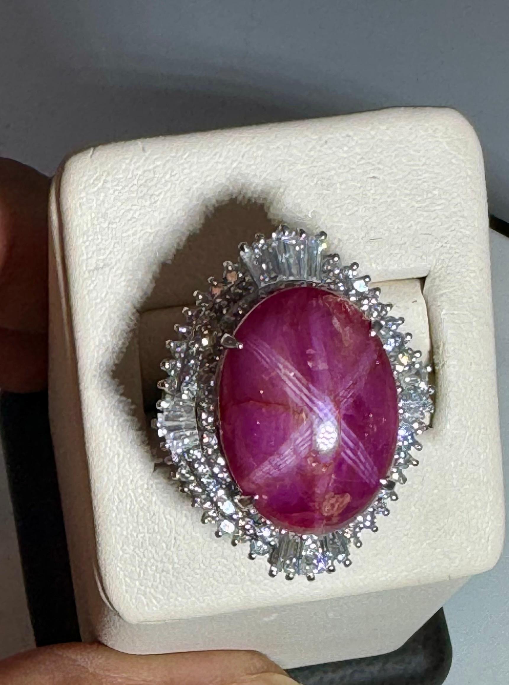 A classic, Cocktail ring 
Exact   21.01 Carat of  natural  Cabochon   with star  Ruby  and  2.45 Ct of Baguettes and Round Diamond Ring
Star  Ruby Cabochon 21.01
Ruby is not red , its pinkish color like Pink Tourmaline.
Platinum 24.3 gm
 all details