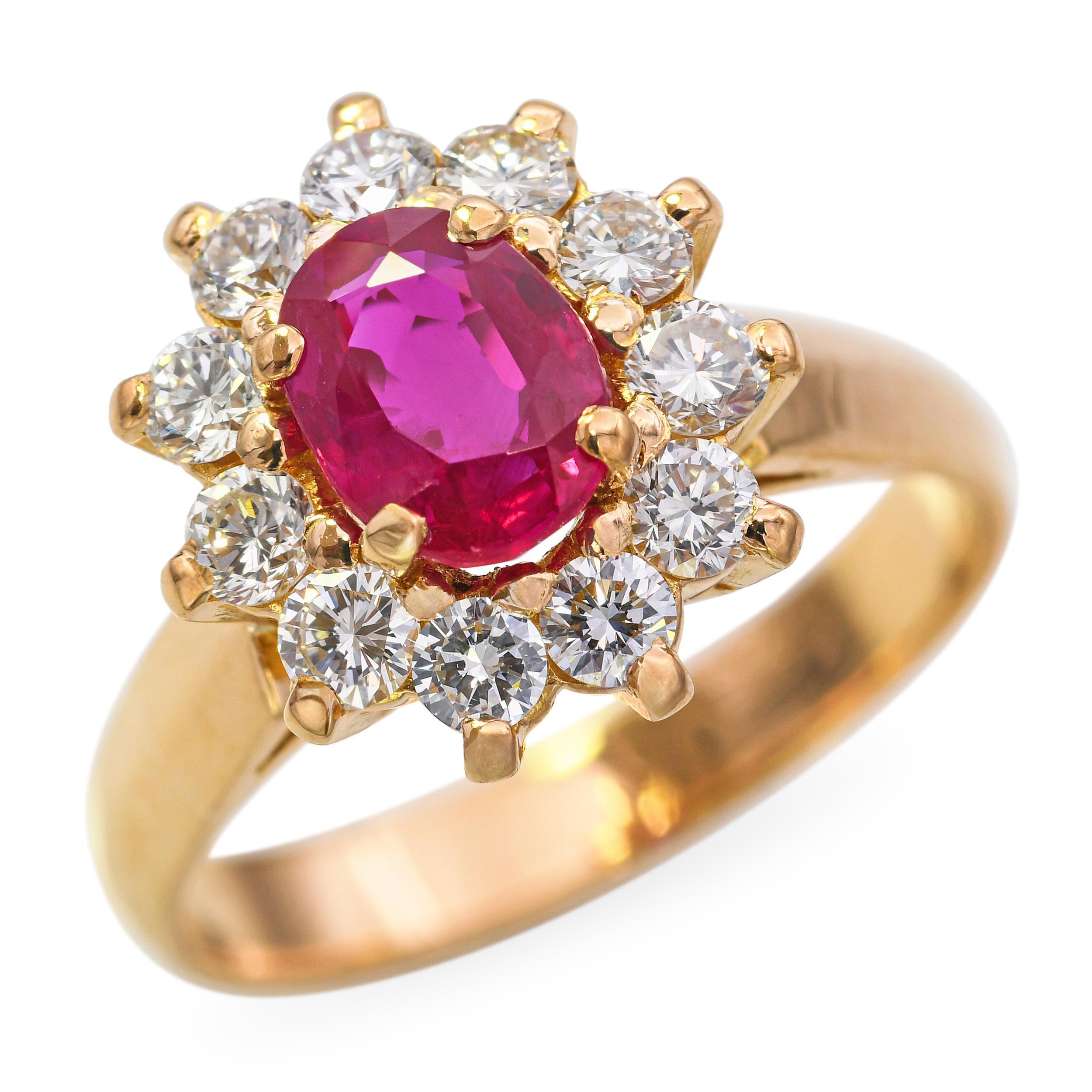 This stunning vintage ring is crafted in 21K yellow gold and features a richly hued ruby at its center. Surrounding the vibrant gemstone is a halo of sparkling diamonds, enhancing its color and adding elegant brilliance. The warm gold setting