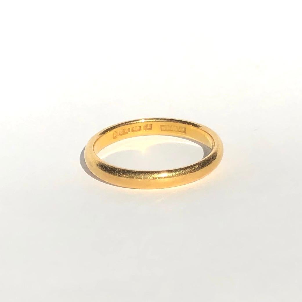 Simple gold bands make the classic wedding band or can be worn as a stylish everyday wear ring to stack or wear alone. Modelled in 22ct Gold and made in London, England. 

Ring Size: M or 6
Band Width: 1.75mm 

Weight: 3.27g