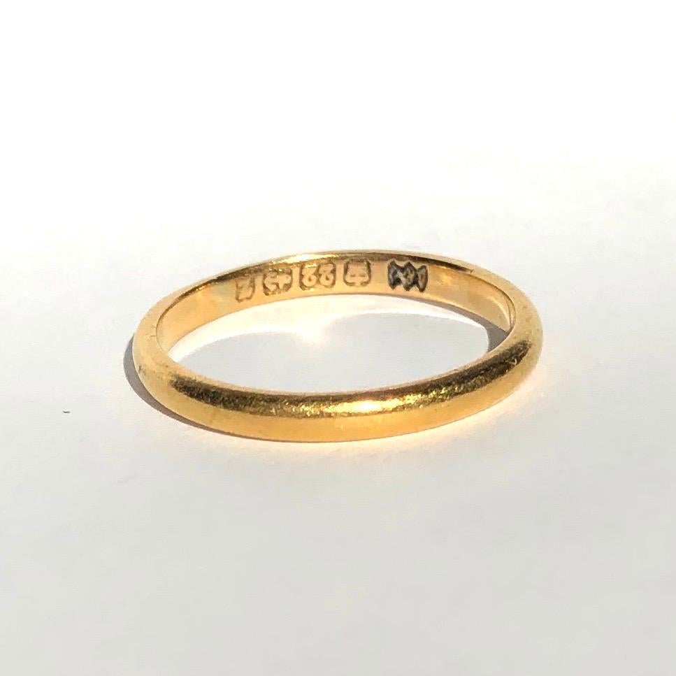 Simple gold bands make the classic wedding band or can be worn as a stylish everyday wear ring to stack or wear alone. Modelled in 22ct Gold and made in Birmingham, England. 

Ring Size: M 1/2 or 6 1/2
Band Width: 2.13mm 

Weight: 2.6g