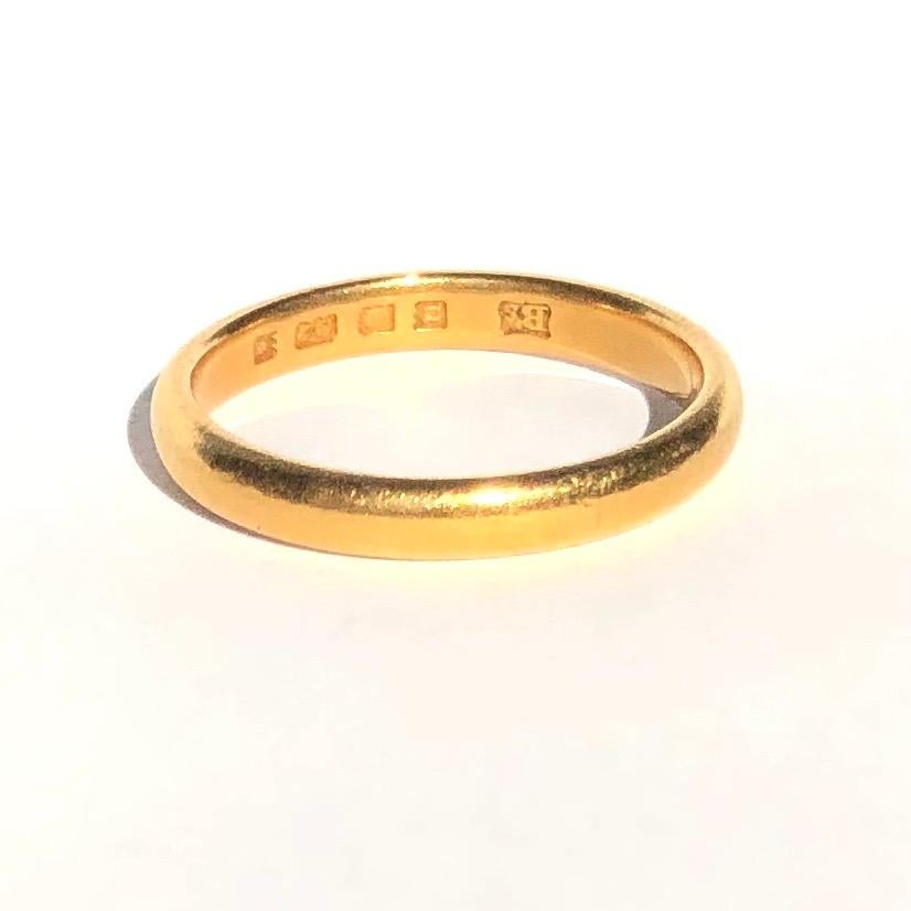 Simple gold bands make the classic wedding band or can be worn as a stylish everyday wear ring to stack or wear alone. Modelled in 22ct Gold and made in London, England. 

Ring Size: L 1/2 or 6
Band Width: 2.91mm 

Weight: 3.68g