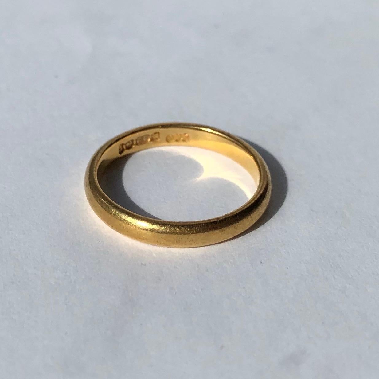 An 22ct gold band makes the perfectly classic wedding band or a great everyday wear piece. Made in Birmingham, England. 

Ring Size: I 1/2 or 4 1/2 
Band Width: 2.5mm 

Weight: 2.76g
