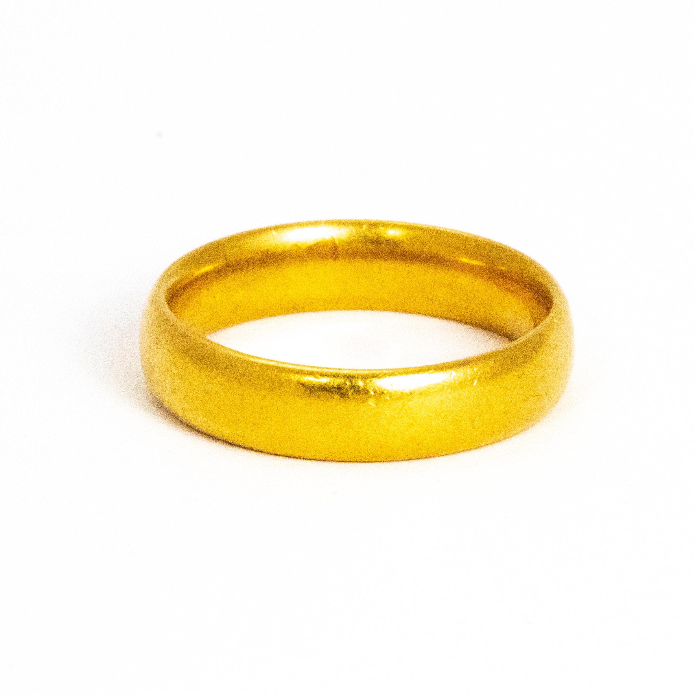 This classic 22ct gold band could be used as a wedding band or a simply lovely everyday ring. Made in Birmingham, England.

Ring Size: M or 6 1/4
Band Width: 4mm