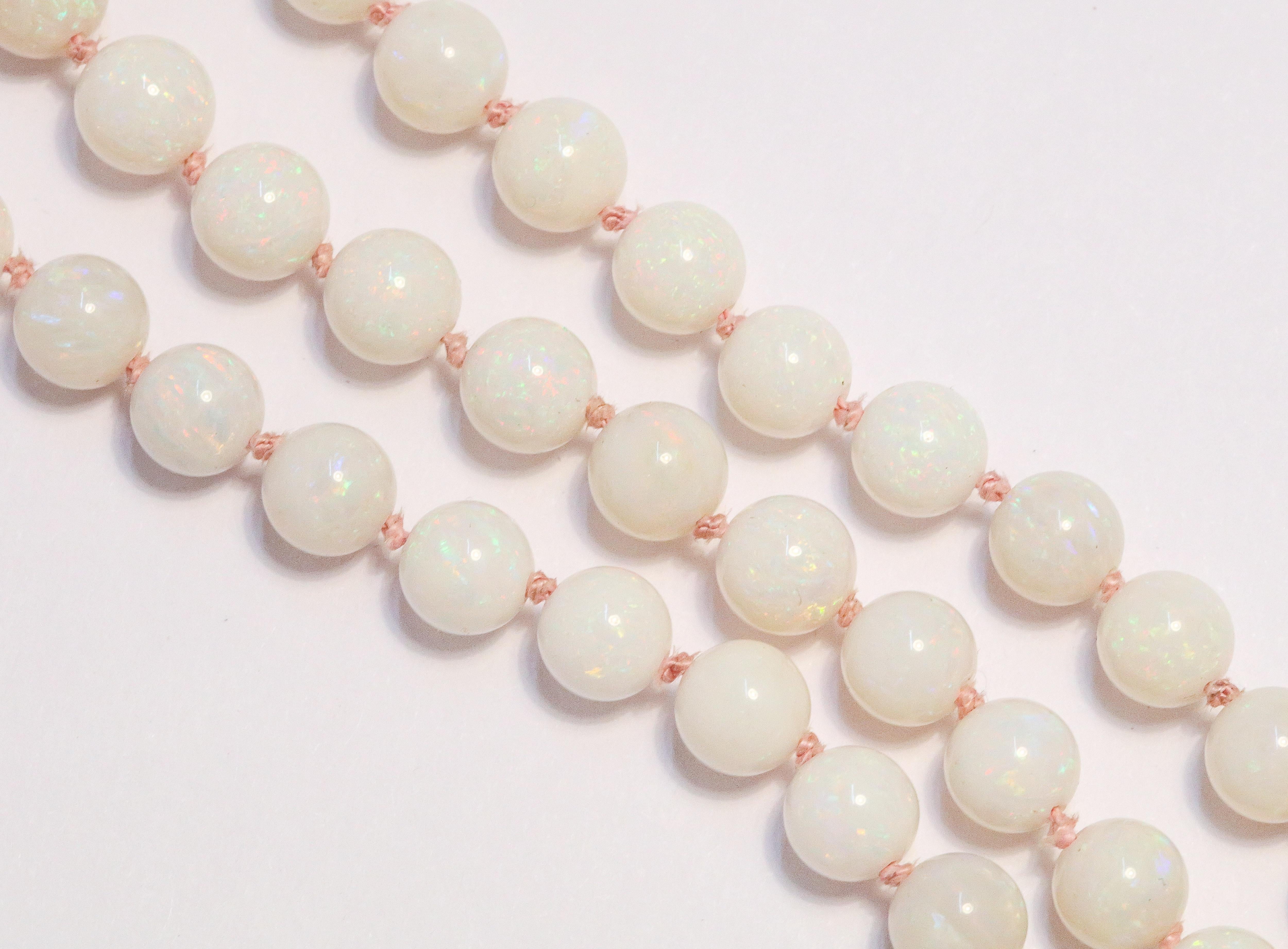 1960's Ladies Iridescent Opal Beaded Necklace.
22 inches Long Necklace
14k yellow Gold Clap
23 Grams of a total 71 opal white beads
6.6mm size of biggest Opal