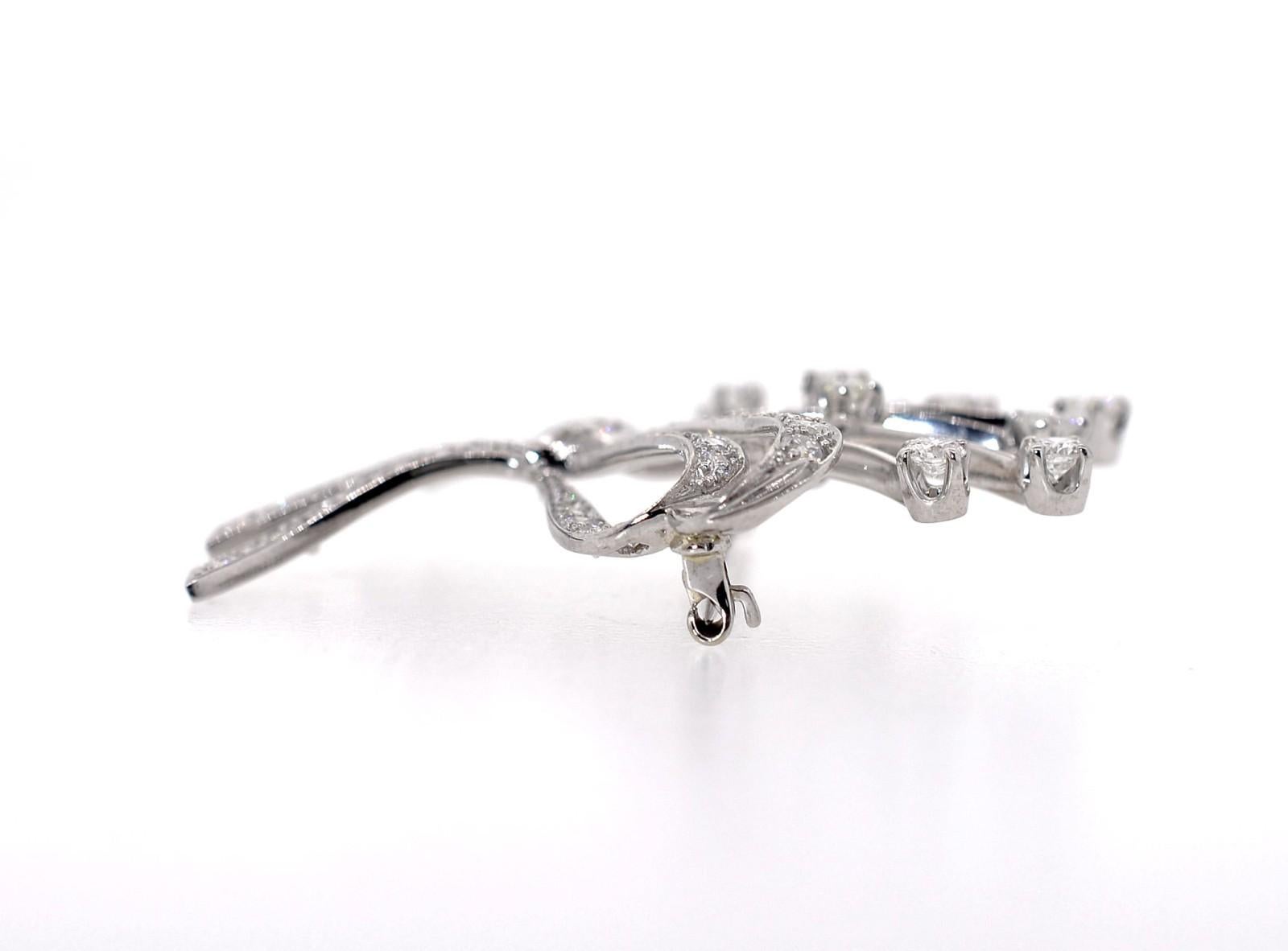 Hand created in the 1960s, this diamond and platinum brooch is a dazzler. Of a spray design with a double bow, it is set with approx. 1.75 carat of sparkling Round Brilliant and approx. 0.45 carat of Single cut diamonds, all totaling approx. 2.20