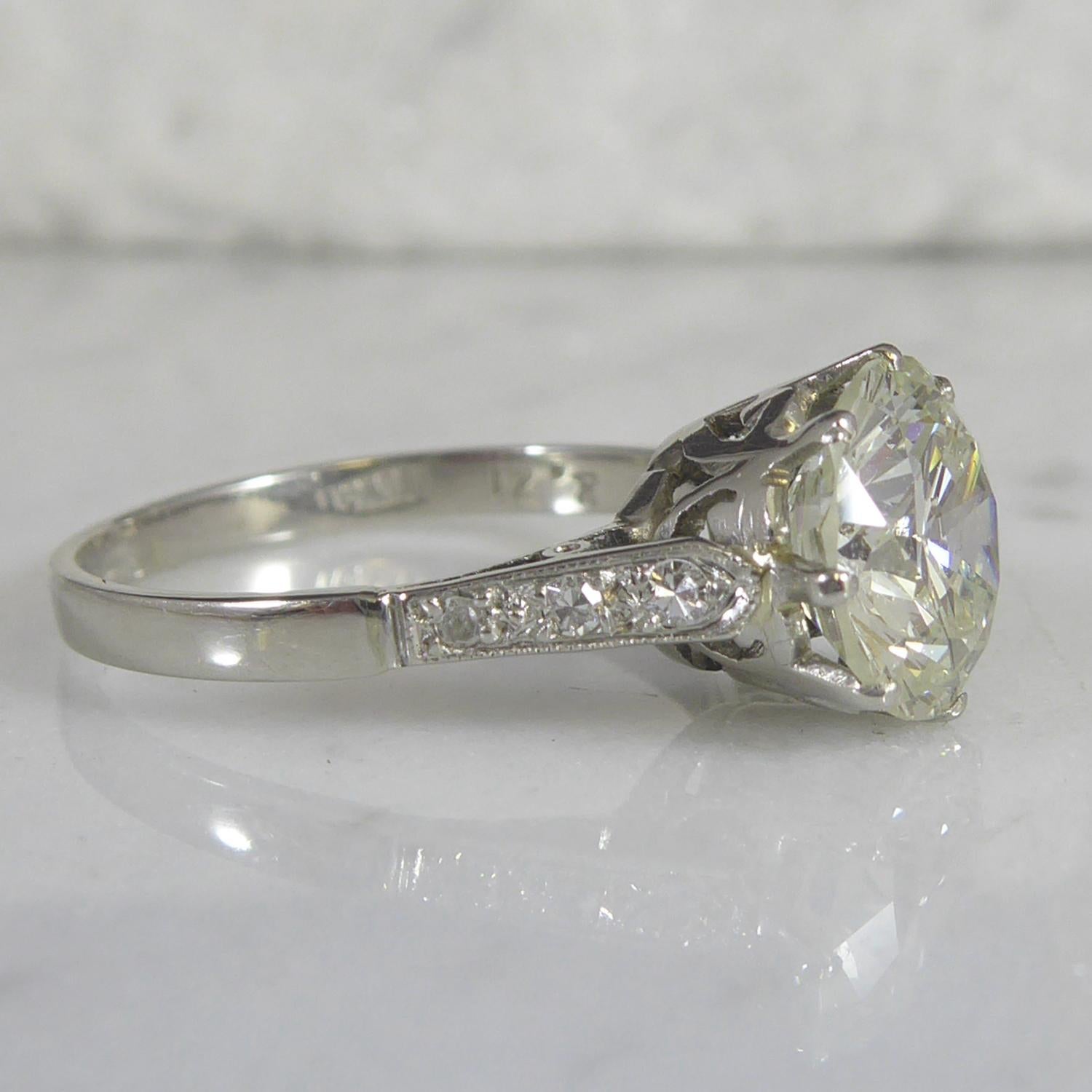 A vintage solitaire diamond engagement or dress ring set with an early round brilliant cut diamond measuring approx. 8.23mm x 8.32mm x 4.95mm deep.  Estimated diamond weight 2.21ct, assessed clarity VS1, assessed colour K/L.  Claw setting in white. 