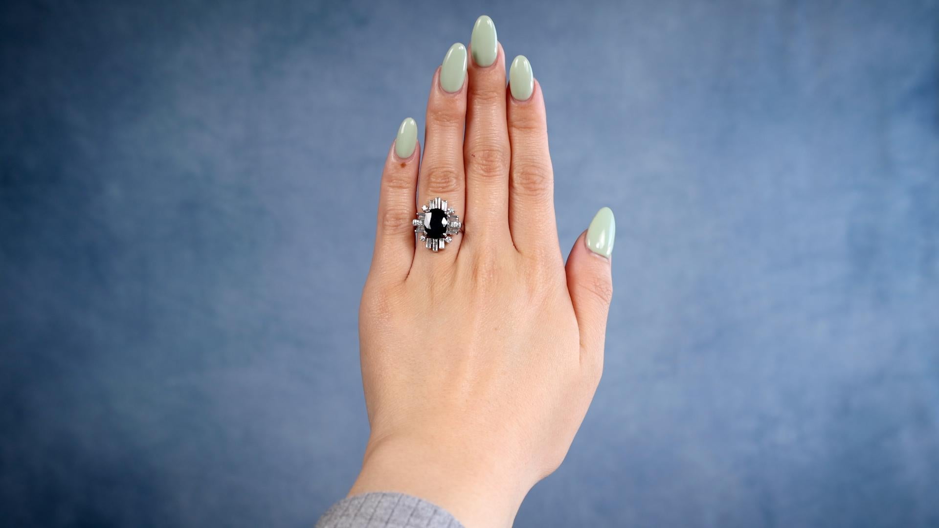 One Vintage 2.25 Carat Sapphire Diamond Platinum Ring. Featuring one oval mixed cut sapphire weighing approximately 2.25 carats. Accented by six baguette and six round brilliant cut diamonds with a total weight of approximately 0.40 carat, graded