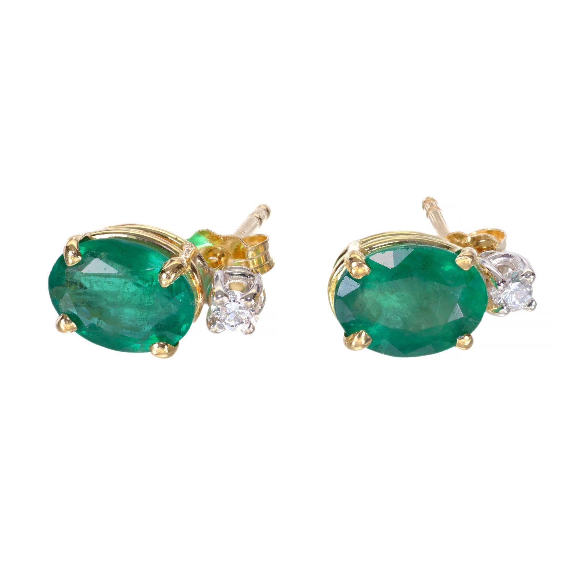Simple 18k yellow and white gold basket earrings from the Peter Suchy Workshop set with two oval Emeralds and two round accent diamonds. 

2 oval Emeralds approx. total weight 2.25cts
2 round diamonds approx. total weight .03cts, G, VS
18k Yellow