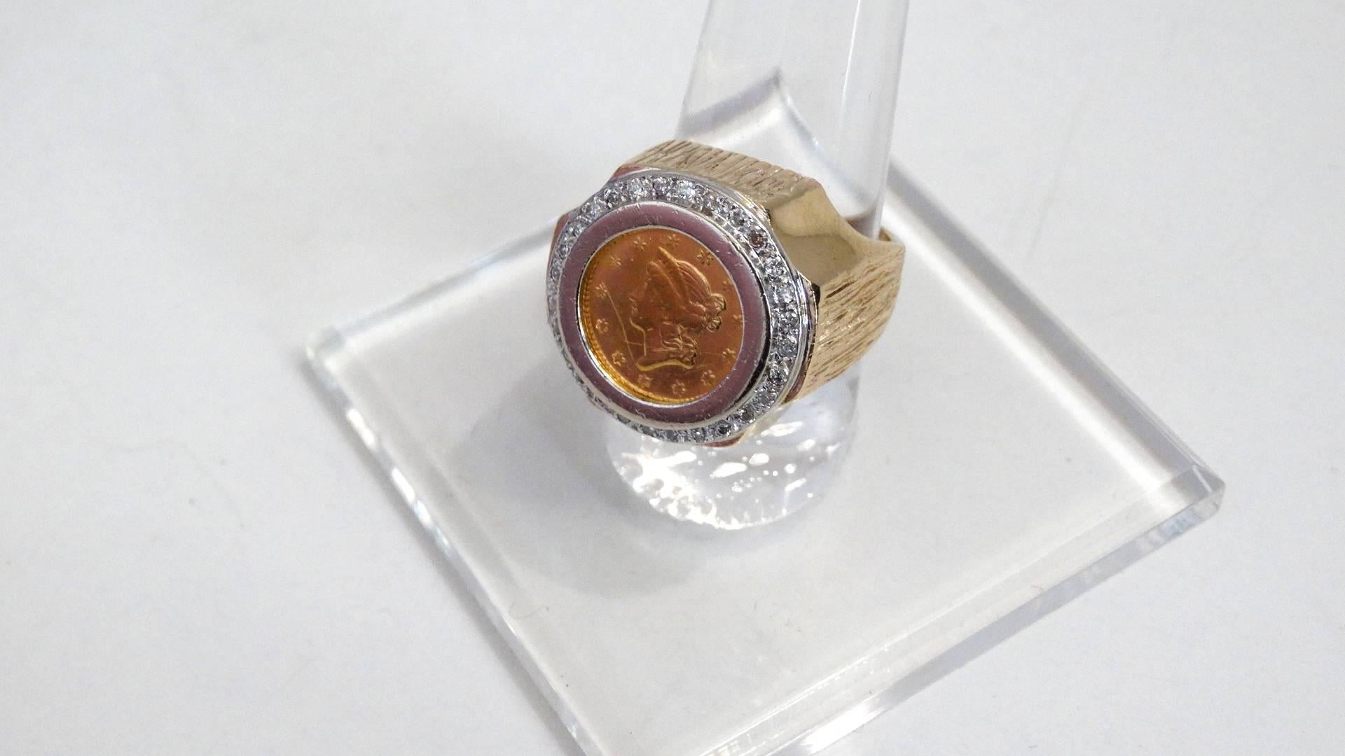 Vintage unisex 1852 $1 Dollar gold coin ring surrounded by diamond accents. Heavy with the ring weight at 17.75 grams the ring is 14k and the liberty head coin is solid 22k gold. Size 7, Please note: there is a tiny scratch on the coin see image #4