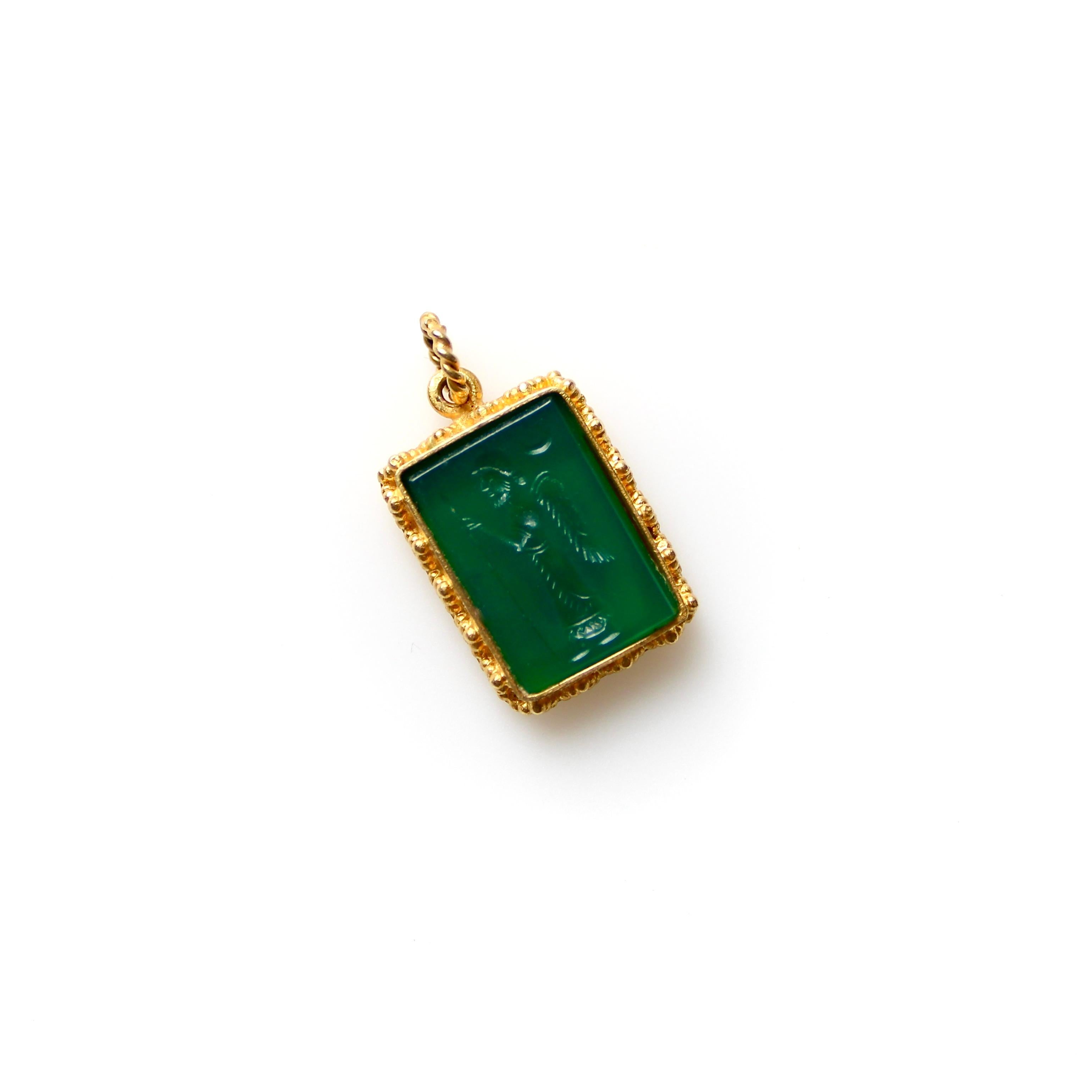 This 22k gold vintage pendant features a green chalcedony intaglio carved with the image Zoroaster. The gold has beautiful granulation in the style of Etruscan Revival, and the intaglio is bezel set into the pendant and presents itself as a tiny