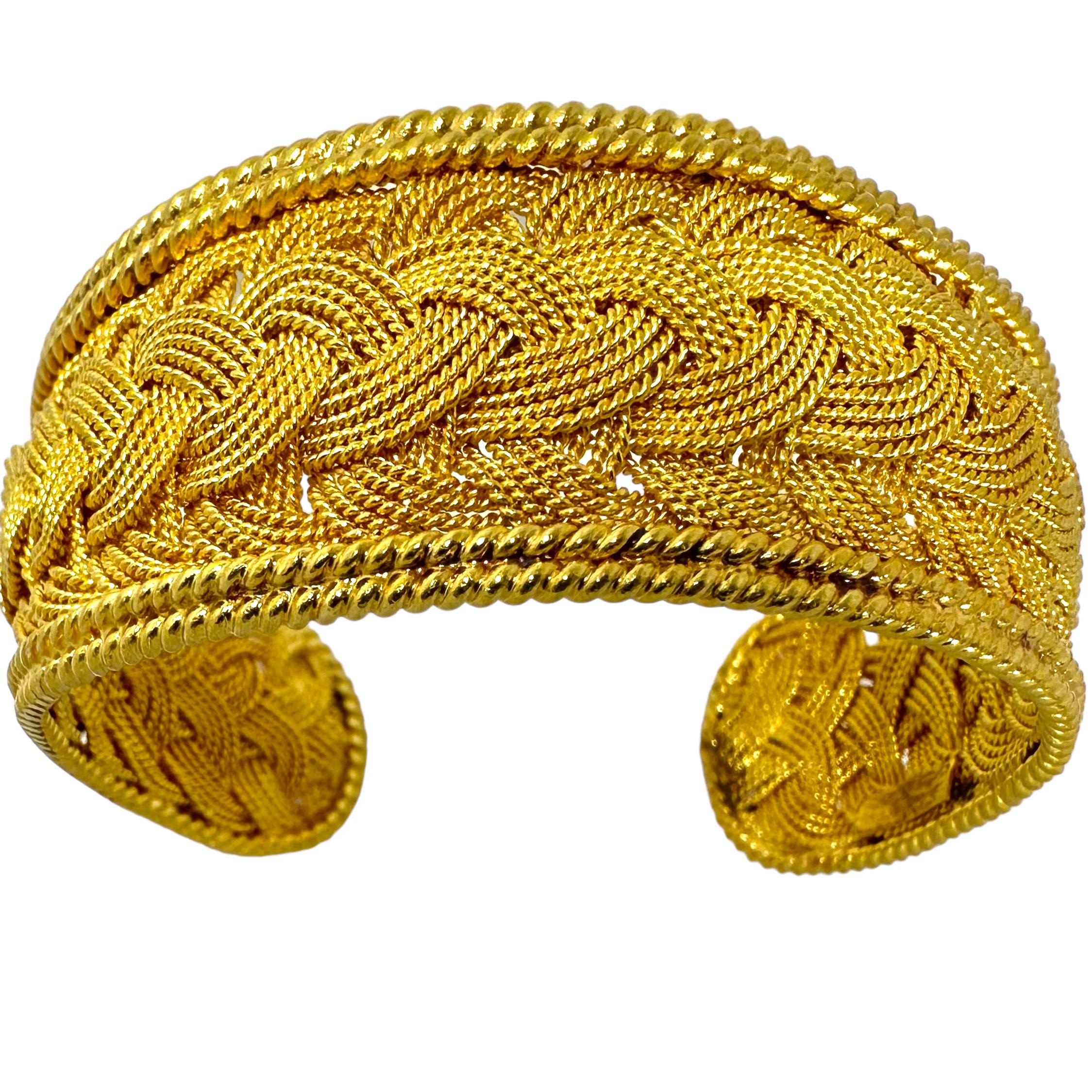 This extraordinary vintage bangle bracelet is a true masterpiece of hand crafting. Long lines of 22k gold have been expertly twisted into gold rope and braided over the bracelet's entire surface. All edges are crafted in a double line of hand