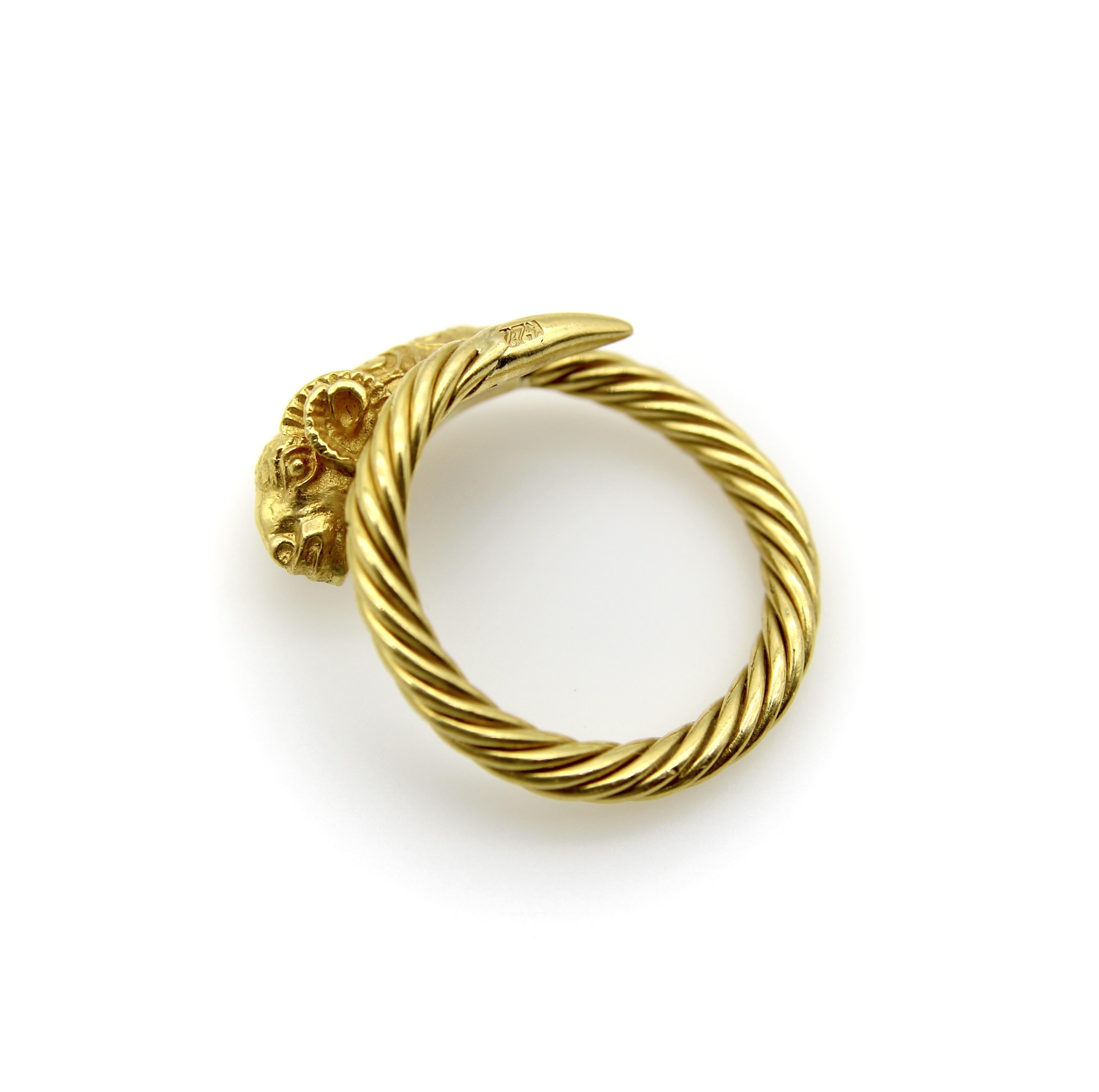 This 22k gold ram’s head ring has the glow and allure of high karat gold. The ram’s head features Etruscan Revival scrolling, spiraling horns, and an expressive face. The ring shank is made of twisted 22k gold wire that narrows to a point. Because
