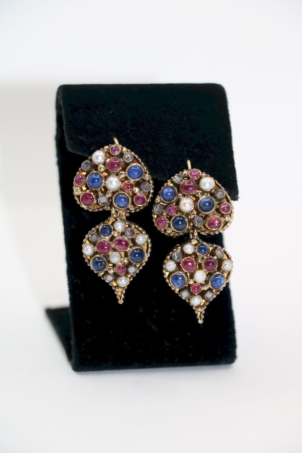 Vintage 22K Gold Indain Mughal Gem Set Earrings
Rare Example - Vintage 22K Gold Indain Mughal Gem Set Earrings Included Ruby, Sapphire, Pearl and  Diamond.

Approximate Dimensions:
4.3 cm ( Length) 
2.1 cm (Width) 
19.5 grams in weight.
