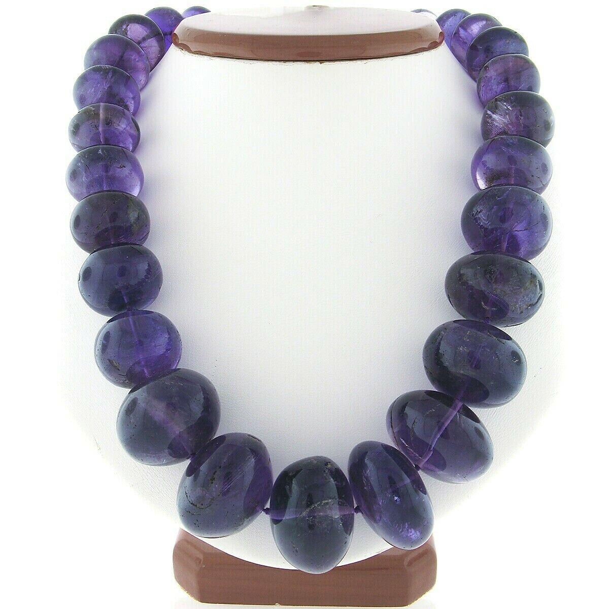 This magnificent vintage strand necklace was neatly strung with 32 natural genuine amethyst in which graduate from 15.6mm to 26mm in diameter throughout. Each of these rondelle shaped stones have a nice polished finish and display an absolutely