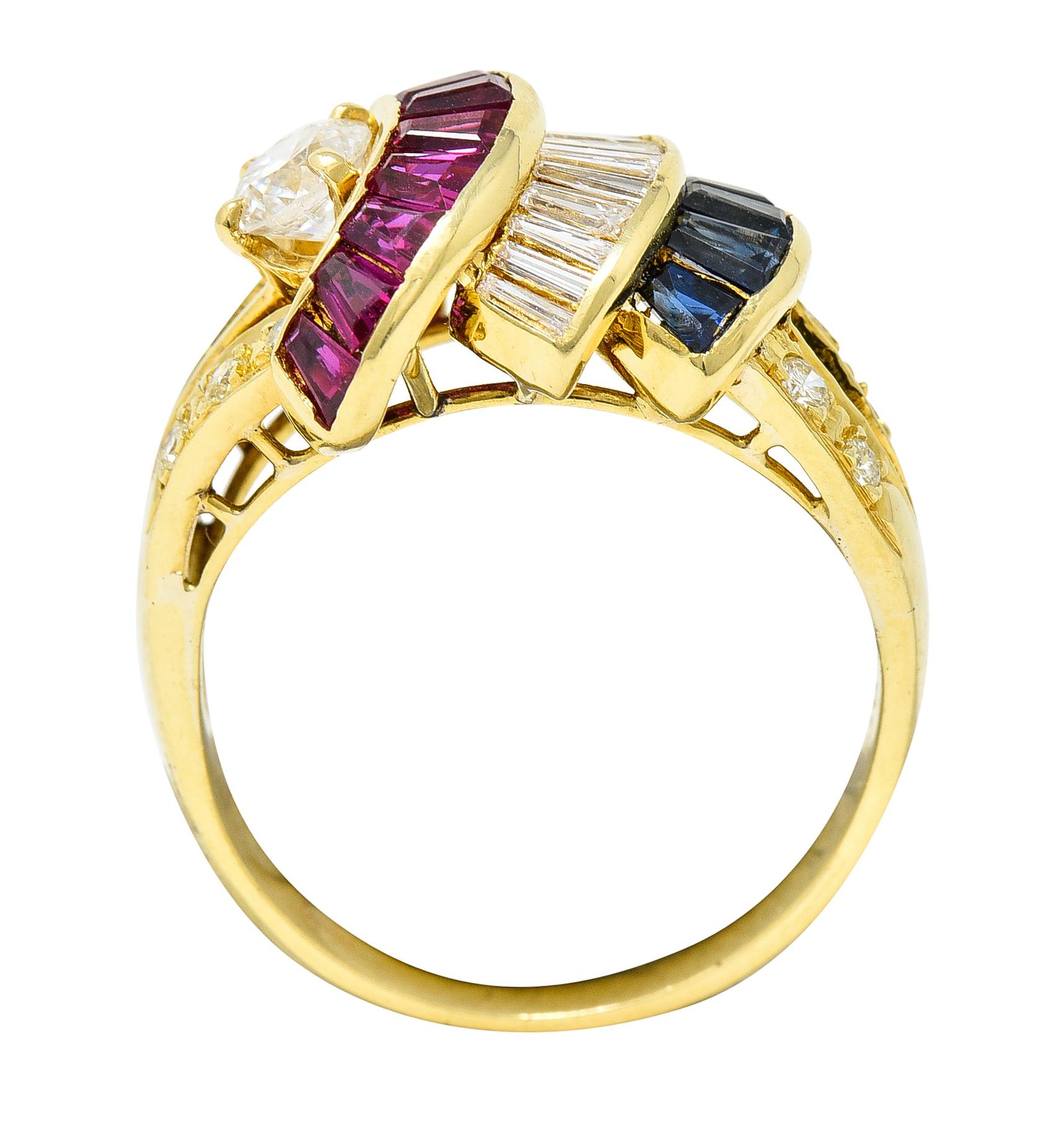 Band ring is designed with split shoulders and features tiered arch forms. With a prong set round brilliant cut diamond weighing approximately 0.25 carat - F color and SI2 clarity. Accompanied by channel set rubies and sapphires - medium dark blue