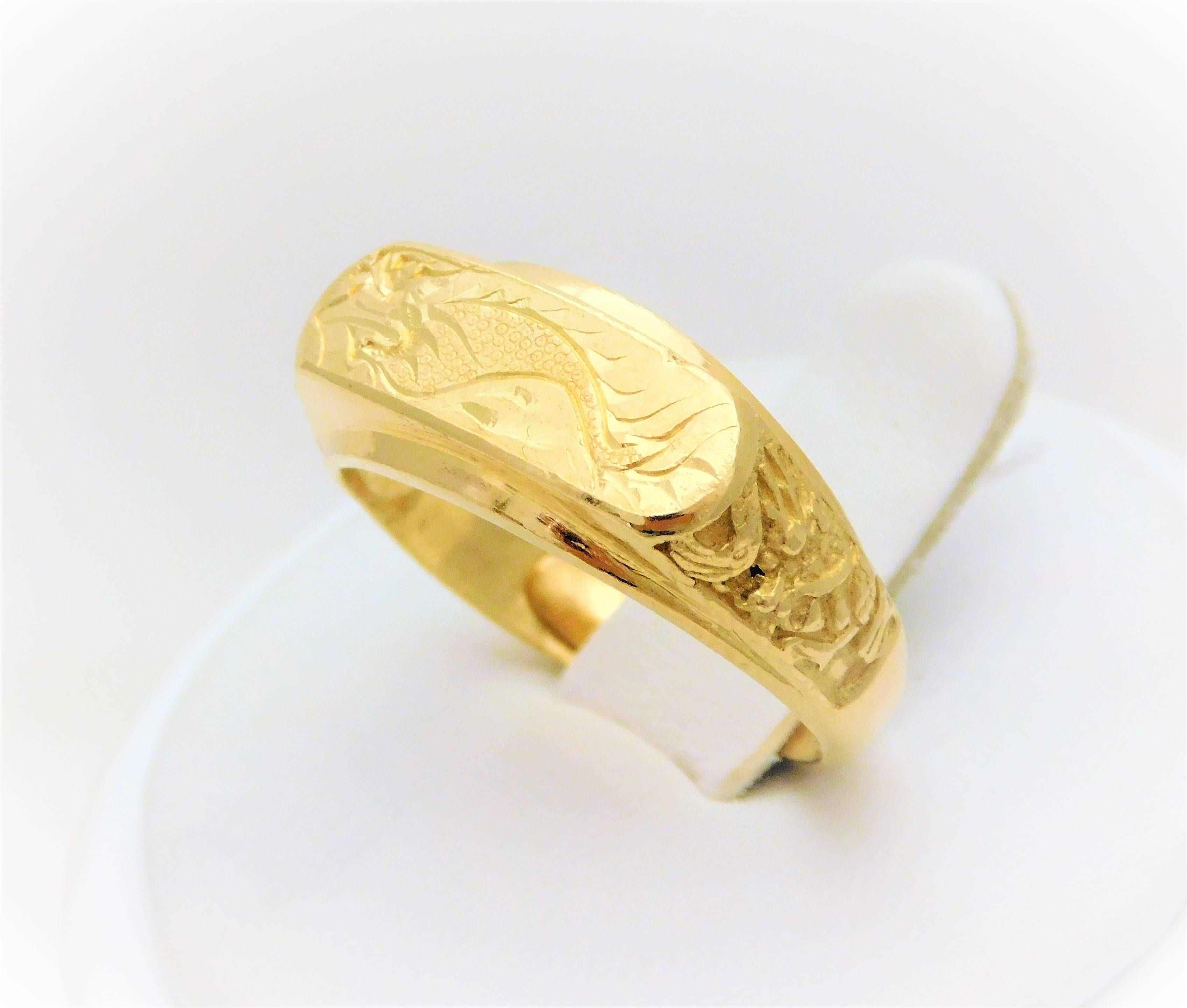 From a Chinese estate.  Circa 1940-1960.  This magnificent ring has been hand crafted in solid 23k yellow gold.  It features all original hand engravings including the exceptionally detailed dragon design on the front of the head.  All of the