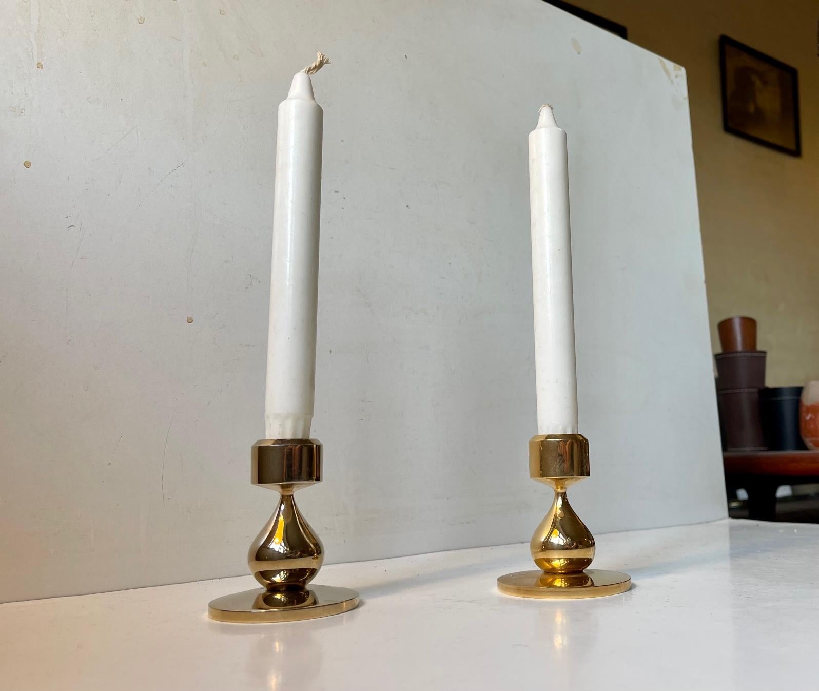 A pair of organically teardrop shaped 24-carat gold-plated candleholders designed by Hugo Asmussen. Manufactured by Asmussen in Denmark circa 1970. They are suited for regular sized candles. Measures: Height: 8 cm, Diameter: 7 cm (base).