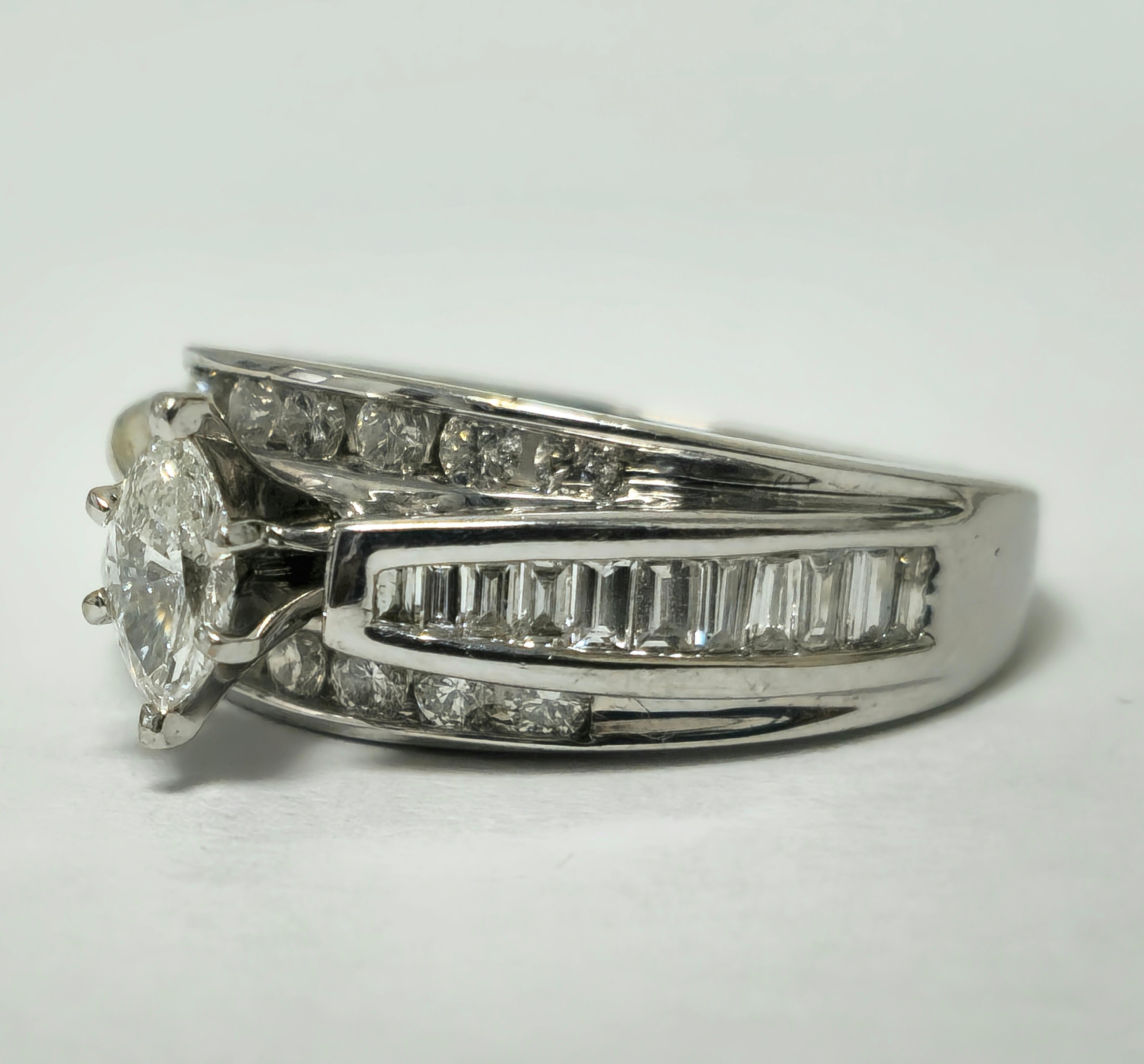 Fashioned from luxurious 14K white gold, this exquisite ring showcases a total diamond weight of 2.40 carats, featuring a splendid array of marquise, round brilliant, and baguette cuts. With diamonds of VS-SI clarity and F-G color, each stone is