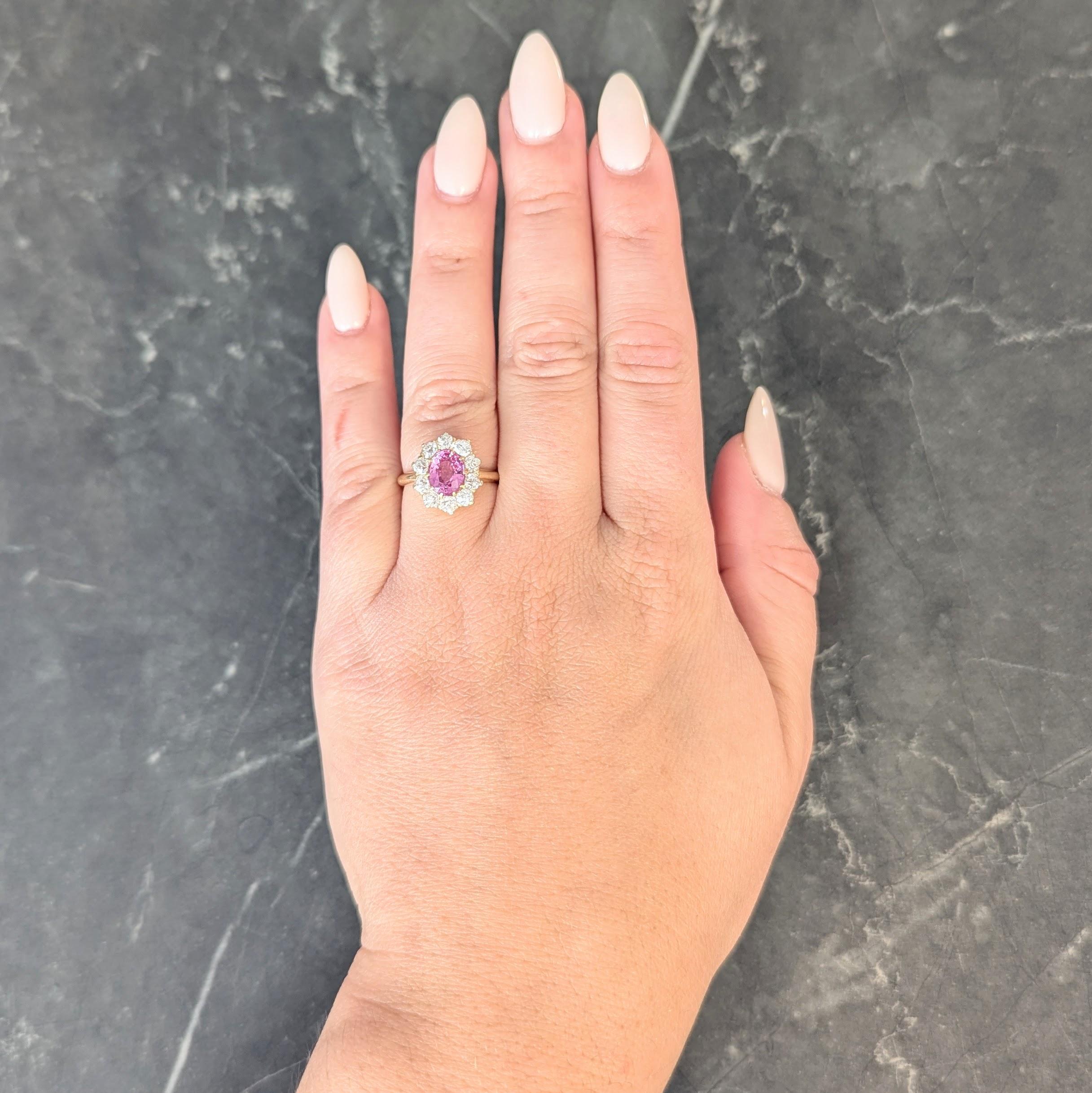 Centering an oval cut sapphire weighing 1.46 carats - transparent medium pink
Natural Madagascar in origin with no indications of heat treatment
Prong set with a halo surround of old European cut diamonds
Weighing approximately 1.00 carat total
G/H