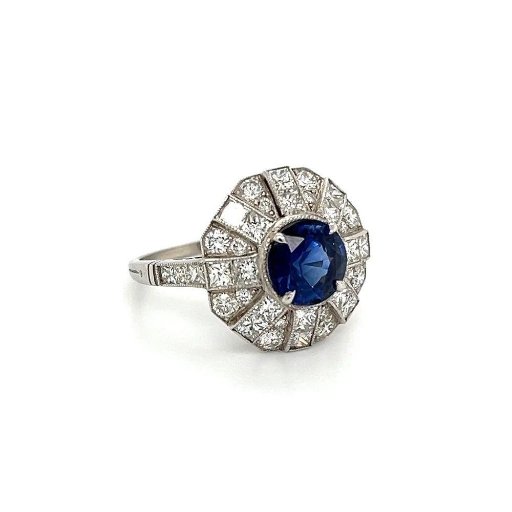 Simply Beautiful! Finely detailed Blue Sapphire and Diamond Vintage Platinum Cocktail Ring. Centering a securely nestled Hand set 2.48 Round Carat Vivid Blue Sapphire, surrounded by Round Brilliant Cut and Square Diamonds, weighing approx. 1.70tcw.