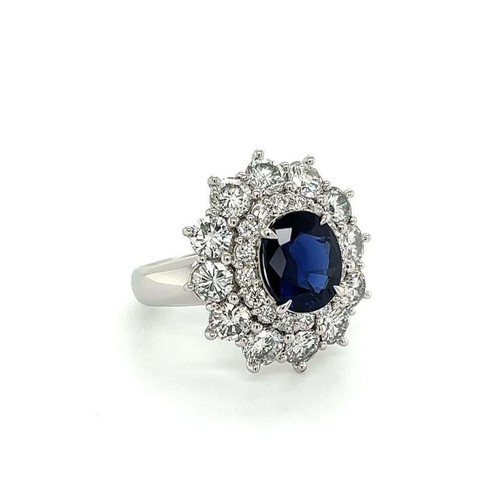 Simply Beautiful! Vintage Sapphire GIA and Diamond Platinum Cocktail Ring. Centering a securely Hand set 2.49 Carat Oval Blue Sapphire Gemstone surrounded by Diamonds, weighing approx. 2.78tcw. Hand crafted Platinum mounting. Ring size 6.5, we offer