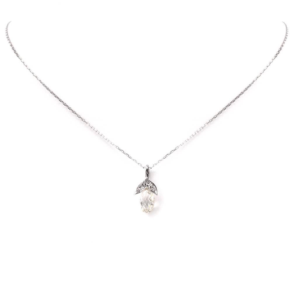 This vintage diamond pendant necklace is crafted in 18K white gold and incorporates an immaculately handcrafted floral motif profiles, centered with one large briolette cut diamond, weighing 2.49 carats, I-J color VS clarity hanging freely. The