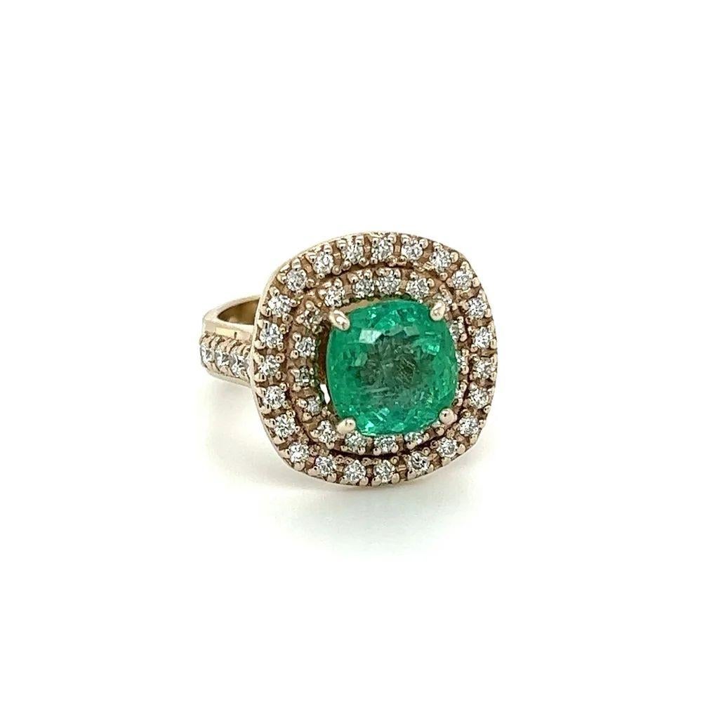 Simply Beautiful! Vintage Cushion Emerald and Diamond Double Halo Gold Cocktail Ring. Featuring a securely nestled 2.50 Carat Cushion Emerald Gemstone, surrounded by Hand set Diamonds, weighing approx. 0.94tcw, including on shank. Hand crafted 14K