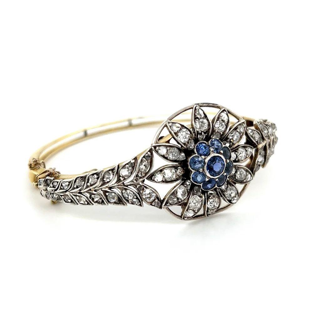Vintage 2.50 Carat Sapphire and Diamond Silver on Gold Cuff Bracelet Simply Beautiful! Elegant and Finely detailed Blue Sapphire and Diamond Vintage Bracelet. Centering a securely nestled Hand set Blue Sapphire, weighing approx. 2.50 Carats,