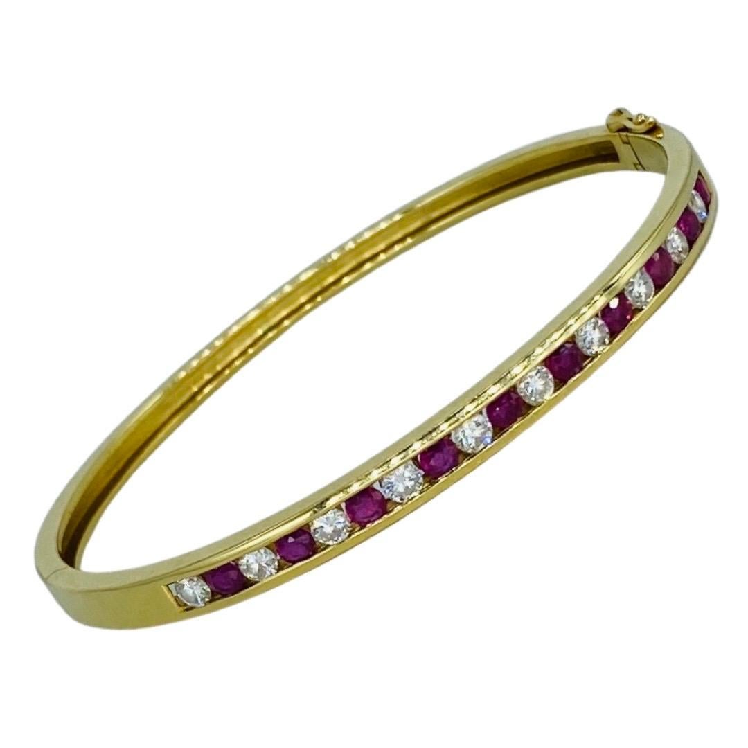 Vintage 2.50 Carat Total Weight Diamonds and Ruby Channel Bangle 18k. Magnificent bangle featuring 1 carat in round diamonds total weight and 1.50 total carat of Ruby gemstones. The bangle measures 4.20mm and will fit up to a 6.5 inch wrist. The