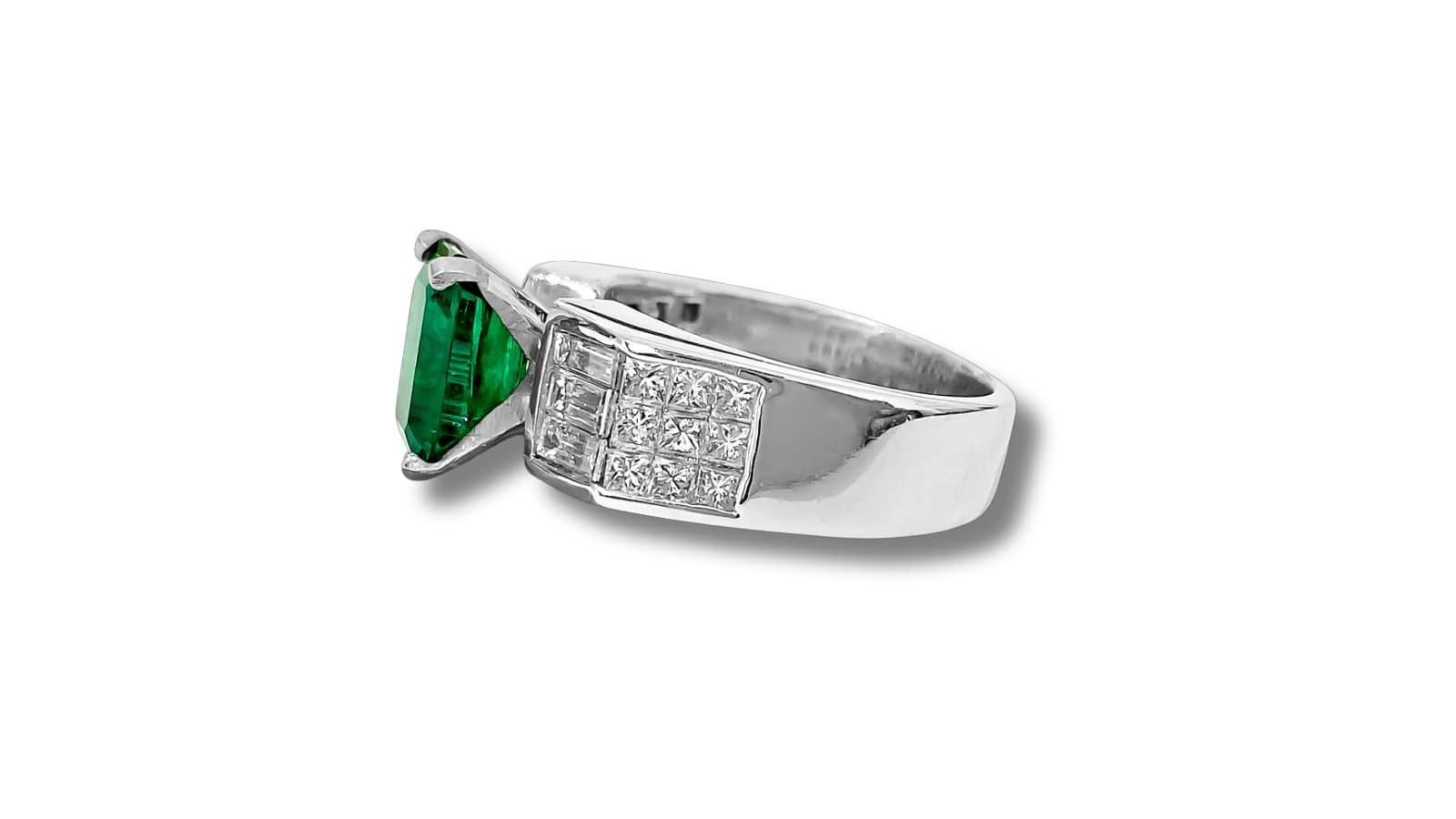 Adorn yourself in elegance with our Solid 18K White Gold Diamond and Emerald Ring, featuring a captivating 2.50 carat princess-cut emerald set in prongs. Complemented by a total of 1.00 carat diamonds, including both baguette and princess cuts, each