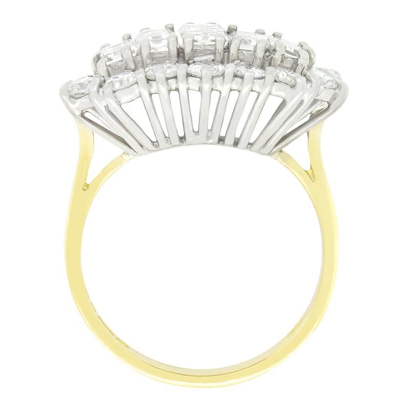 A line of five graduating baguette cut diamonds are encircled in a halo of round brilliant diamonds in this sparkling spray cluster ring. The central of the baguette cut diamonds sits the largest at 0.35 carat, with the flanking pair weighing 0.25