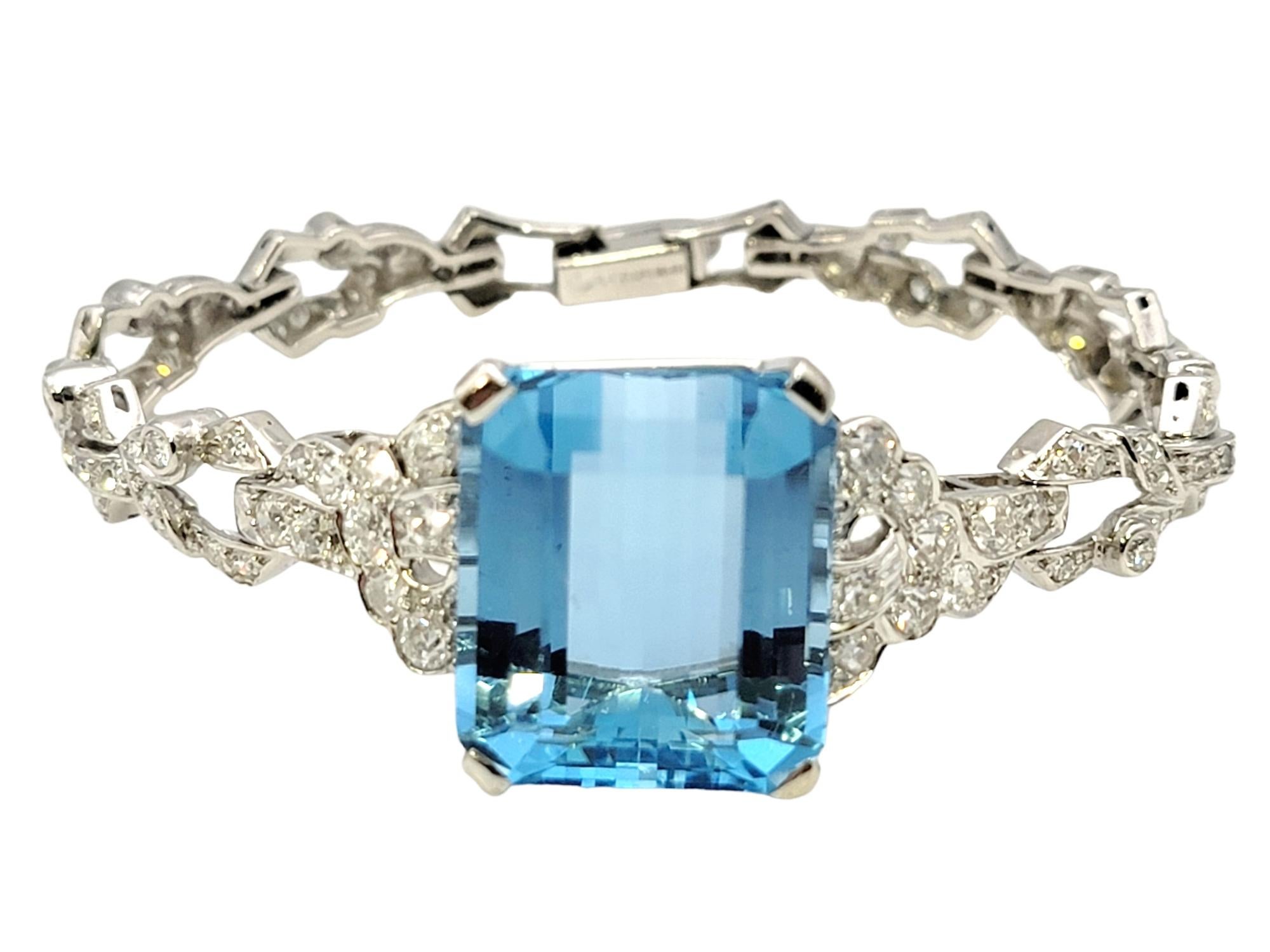 This jaw-dropping, vintage bracelet will absolutely take your breath away. This magnificent piece features a single prong set emerald cut 23.31 carat natural aquamarine stone set at the center of the bracelet.  The impressive colored gemstone is