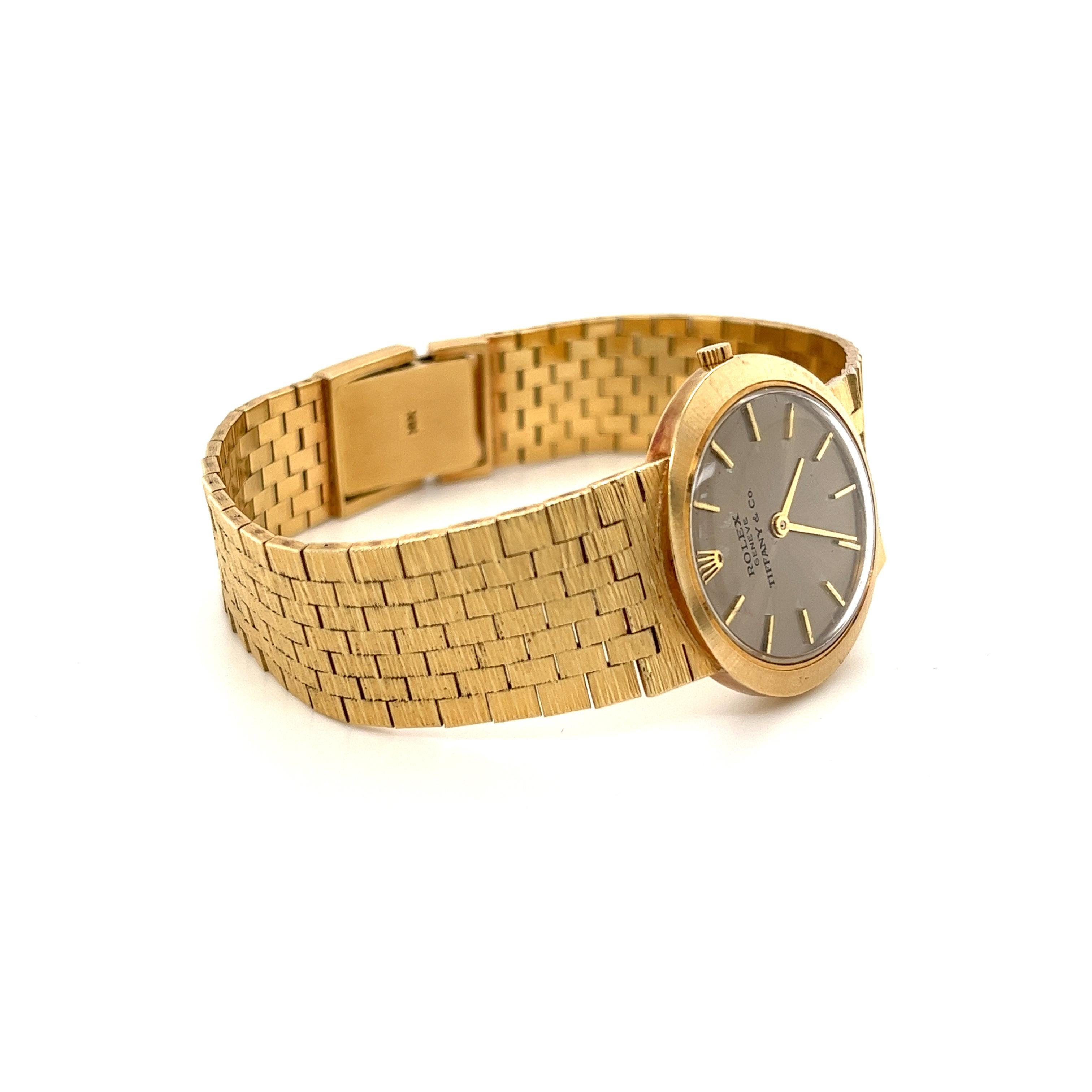 Vintage Rolex swiss-made wristwatch for Tiffany & Co,. Expertly handcrafted with a 14k solid yellow gold integral bracelet. Ideal for the seasoned watch collector and perfect for those in search of a vintage brand watch that isn't the typical cookie