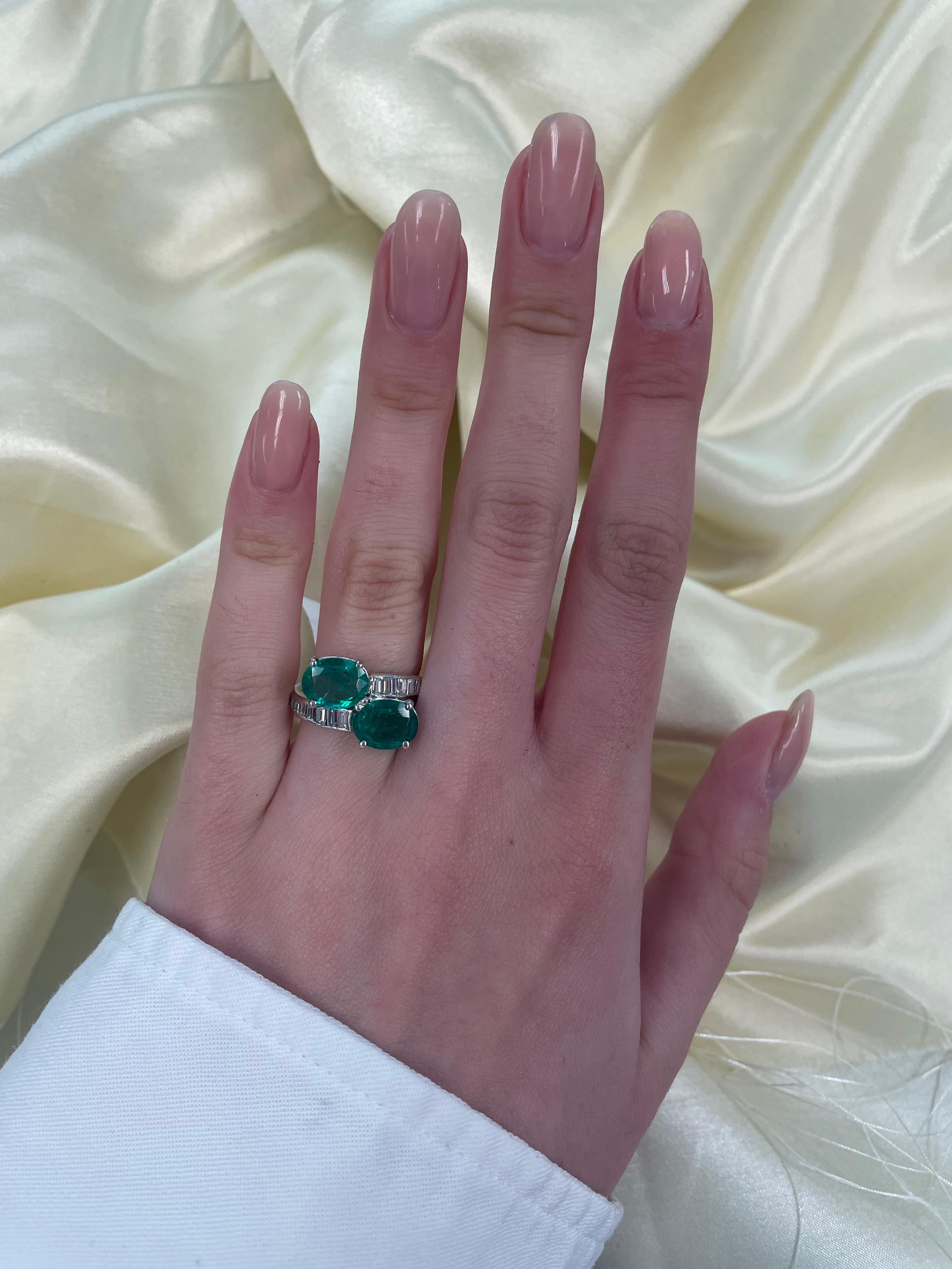 Beautiful vintage emerald and diamond bypass ring.
3.40 carats total diamond weight.
2 oval shape emeralds, 2.62 carats. Approximately 0.78 carats of baguette and tapered baguette cut diamonds, G/H color, VS clarity. 18-karat white gold, current