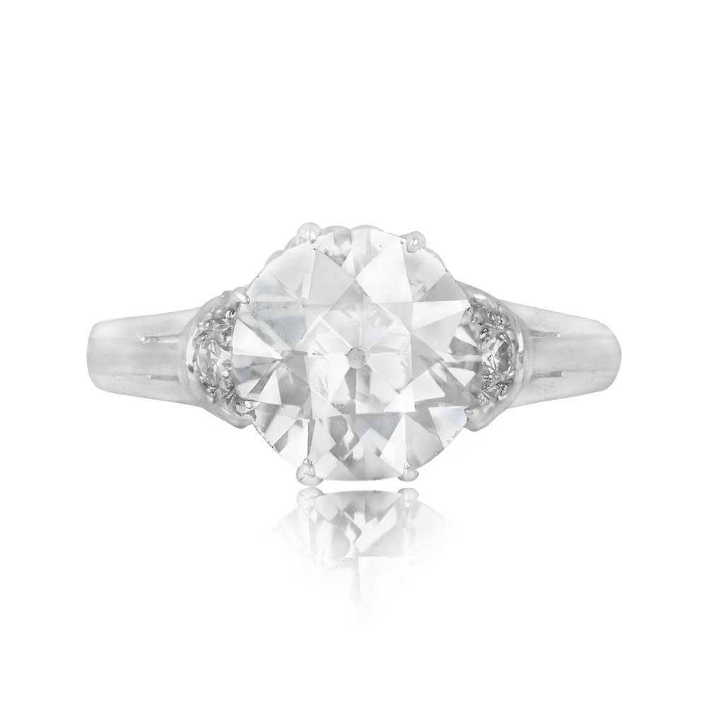This vintage French engagement ring showcases a 2.62-carat old European cut diamond with J color and SI2 clarity, elegantly set in prongs. Single-cut diamonds adorn the curved shoulders, while the under-gallery features an exquisite twist design.