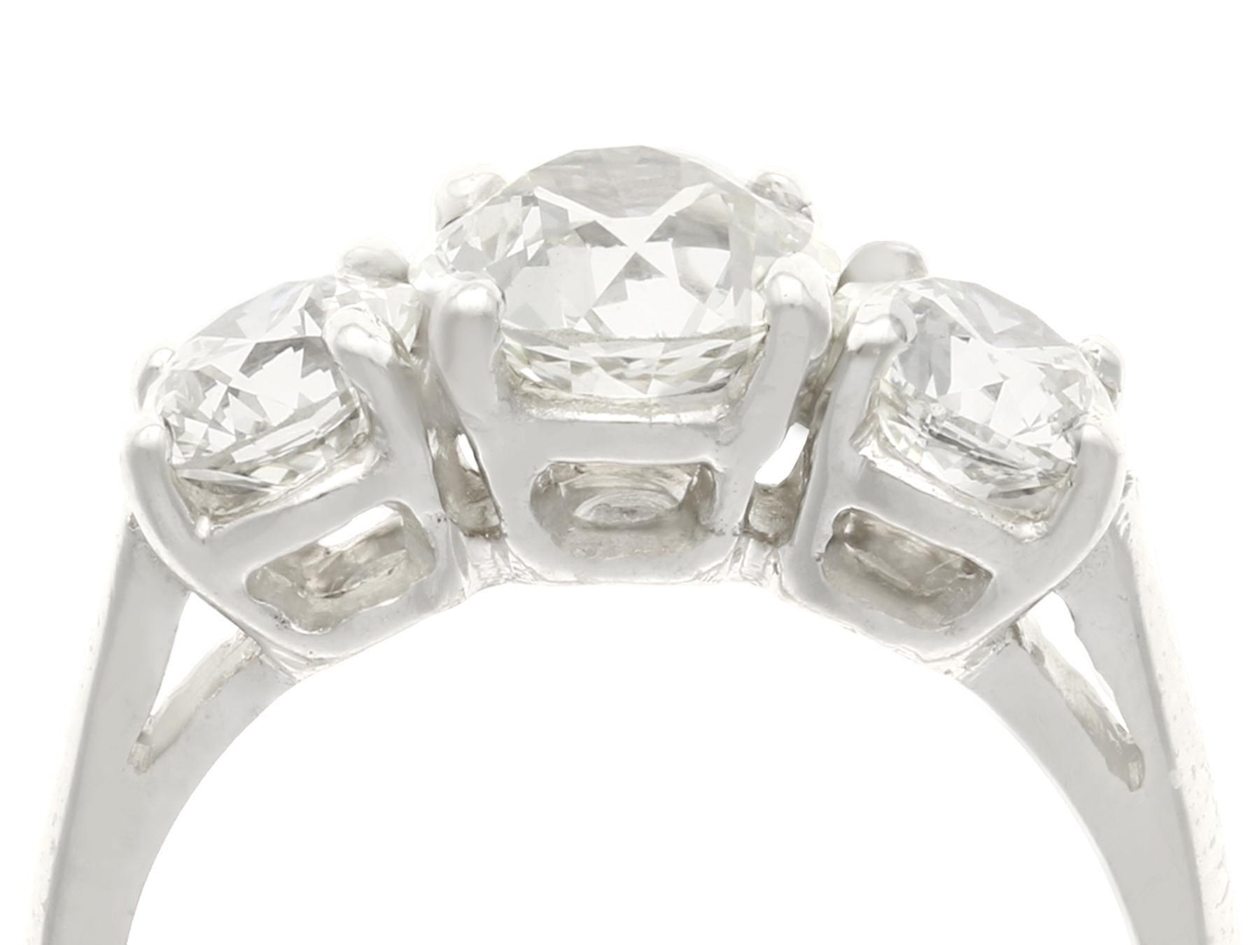 A stunning vintage 2.65 carat diamond and platinum trilogy ring, set with an antique feature diamond; part of our diverse vintage jewelry collections.

This stunning, fine and impressive trilogy ring has been crafted in platinum.

The pierced