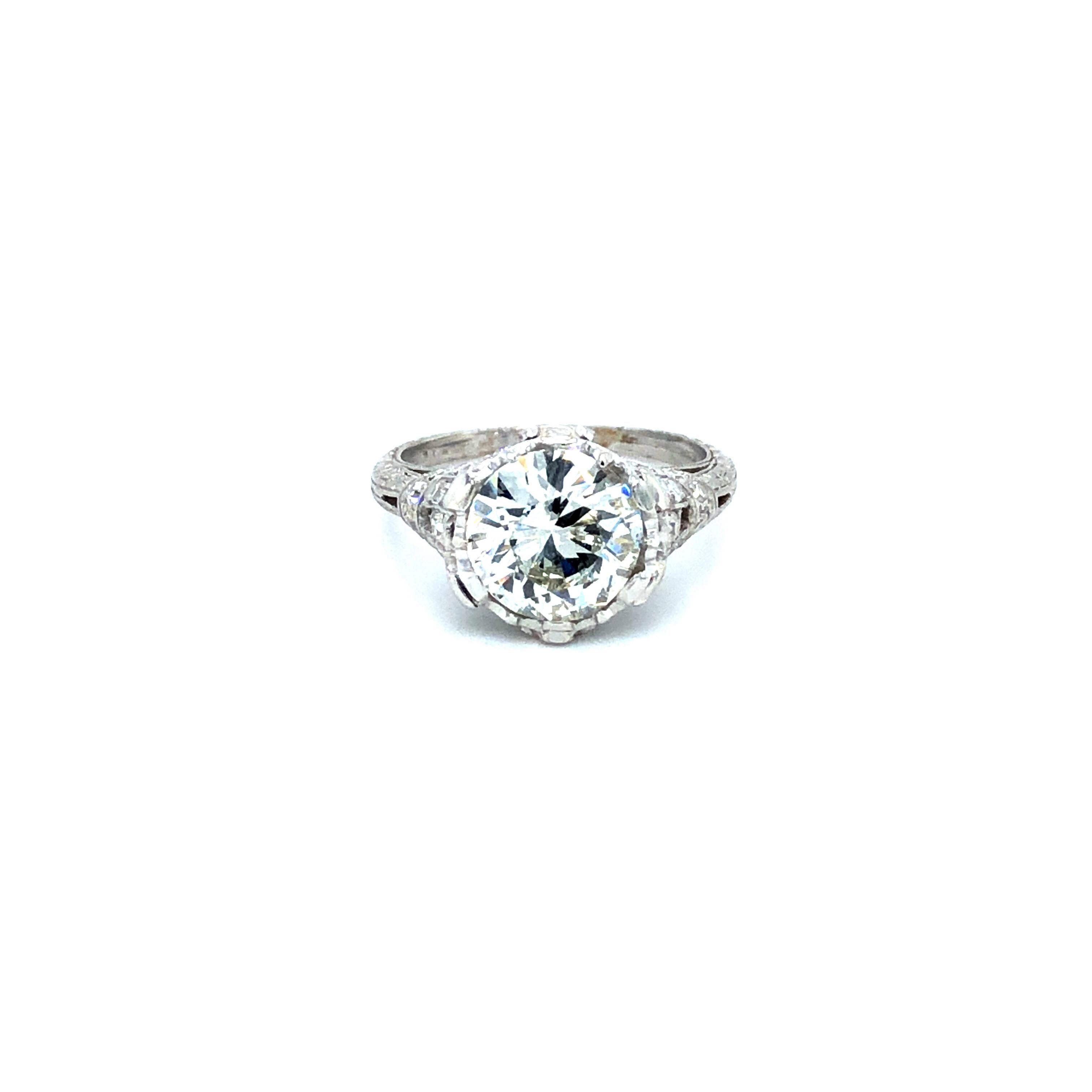 Offered here is a vintage large diamond platinum engagement ring, circa mid last century ( 1950-60 ).
Featuring one natural earth mined diamond with a transitional cut, weighing 2.30 carats, sparkly bright white and fine quality. I-J in color and