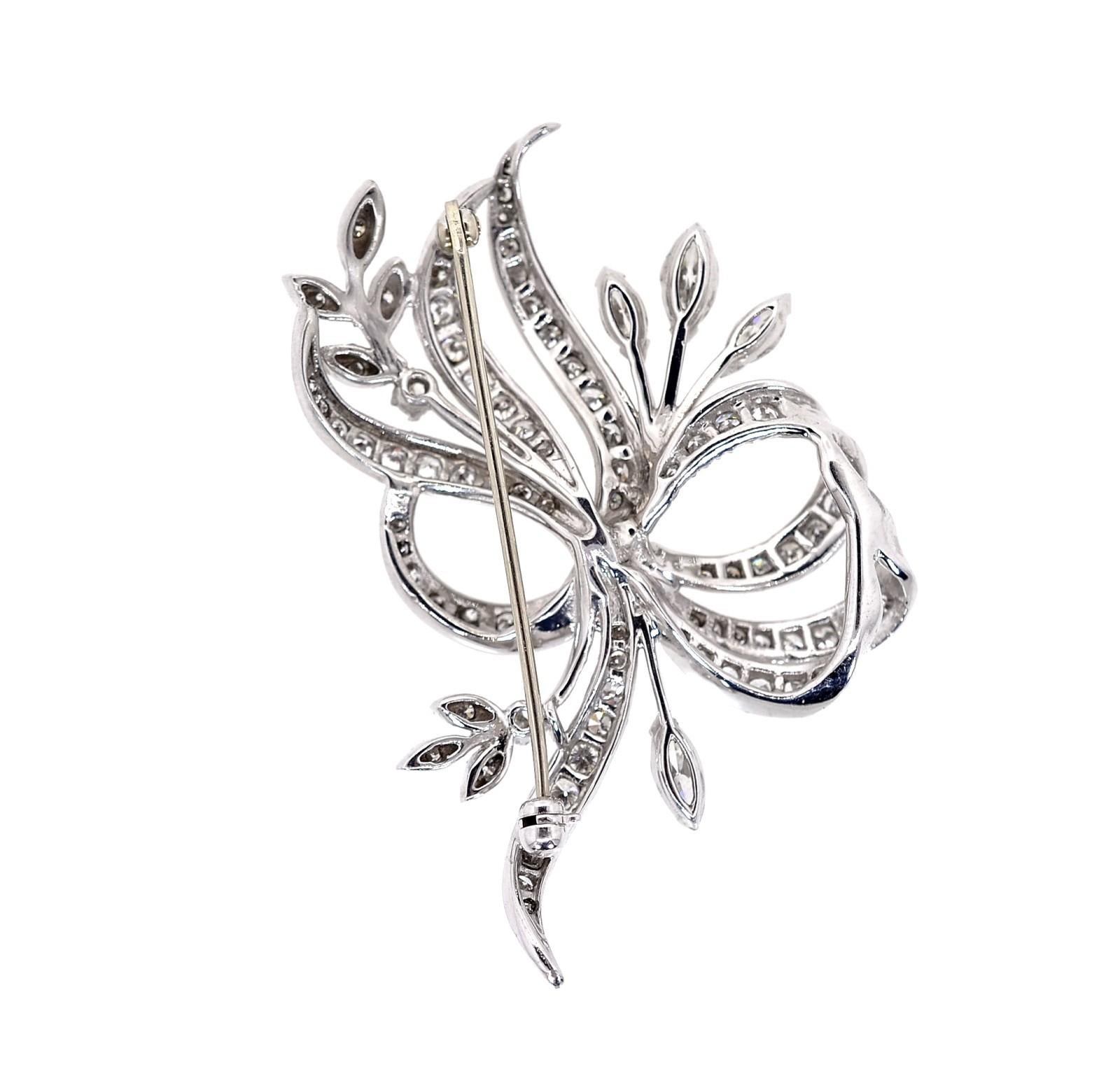 Created in the 1960s, this pretty platinum brooch is of a flowing ribbon design.  It glitters with approx. 2.70 carat of Round and Marquise cut Diamonds of H/I color - VS clarity.  The brooch It is sure to brighten up any outfit at any time.