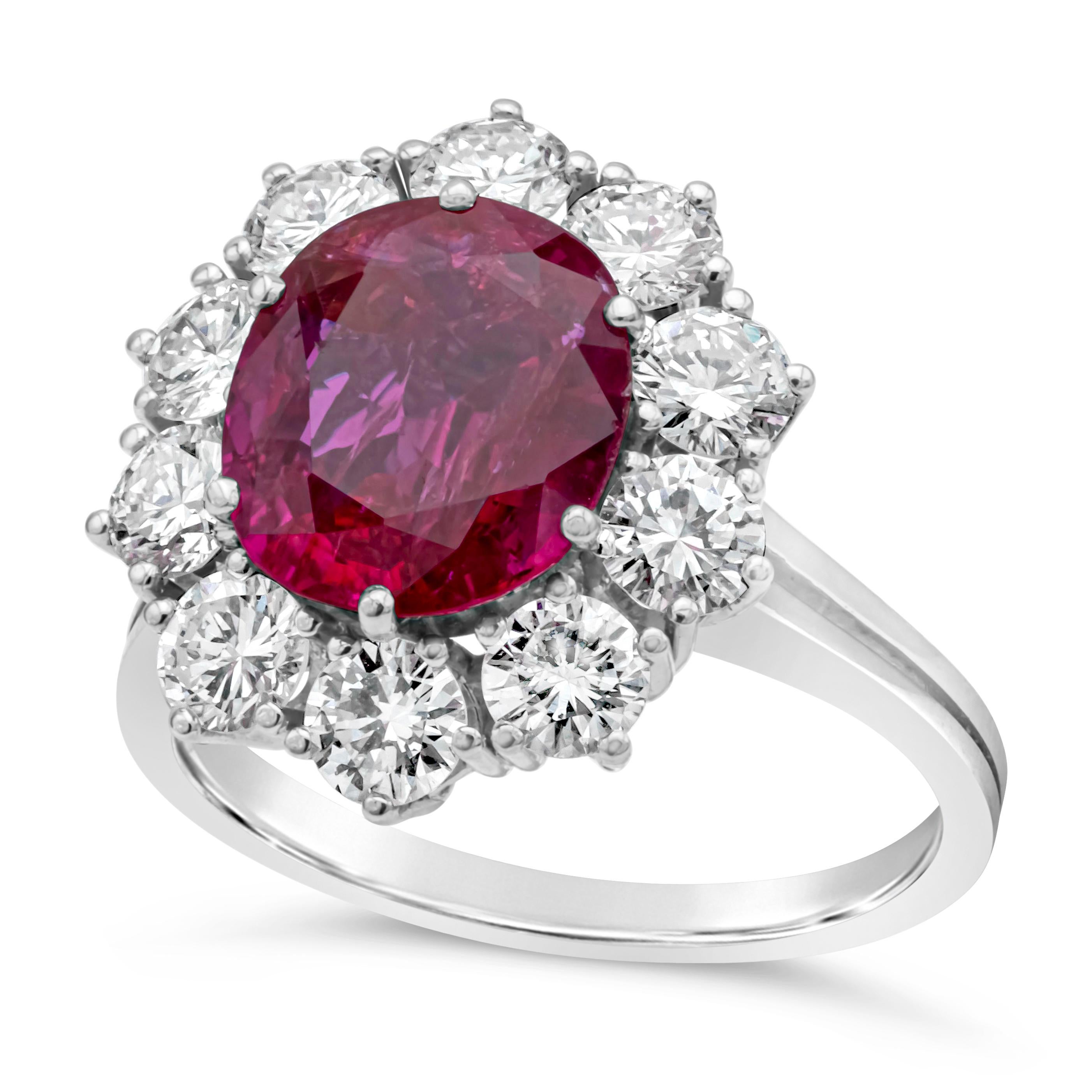 Elegantly crafted halo engagement ring features 2.79 carats color-rich red oval cut ruby certified by AGL as Burmese Origin with no indications of heat treatment.  Set in an intricately-designed halo mounting accented with round brilliant diamonds