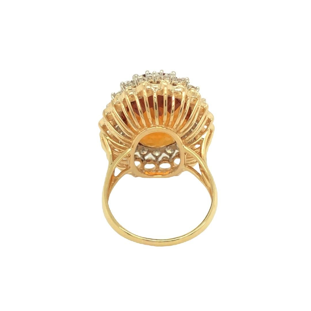 This classic ring is crafted in 18K gold and features a well cut golden colored oval shaped citrine measuring 29.5 mm long x 14.6 mm wide and approximately 11mm in depth. The Citrine is set in fine white gold prongs all around the stone and