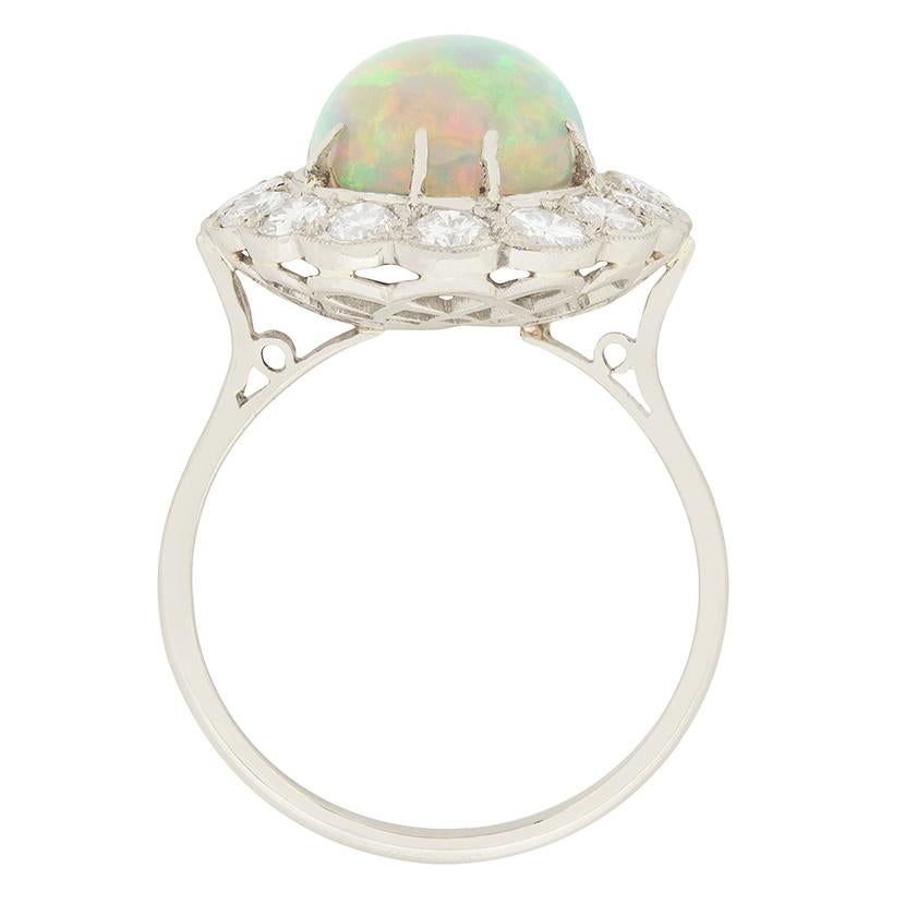 This stunning 2.80 carat opal is surrounded by a halo of diamonds. The oval shaped opal is excellent quality, with beautiful play of colour. A total of 1.60 carat of round brilliant cut diamonds surround the opal. The diamonds are F colour and VS2