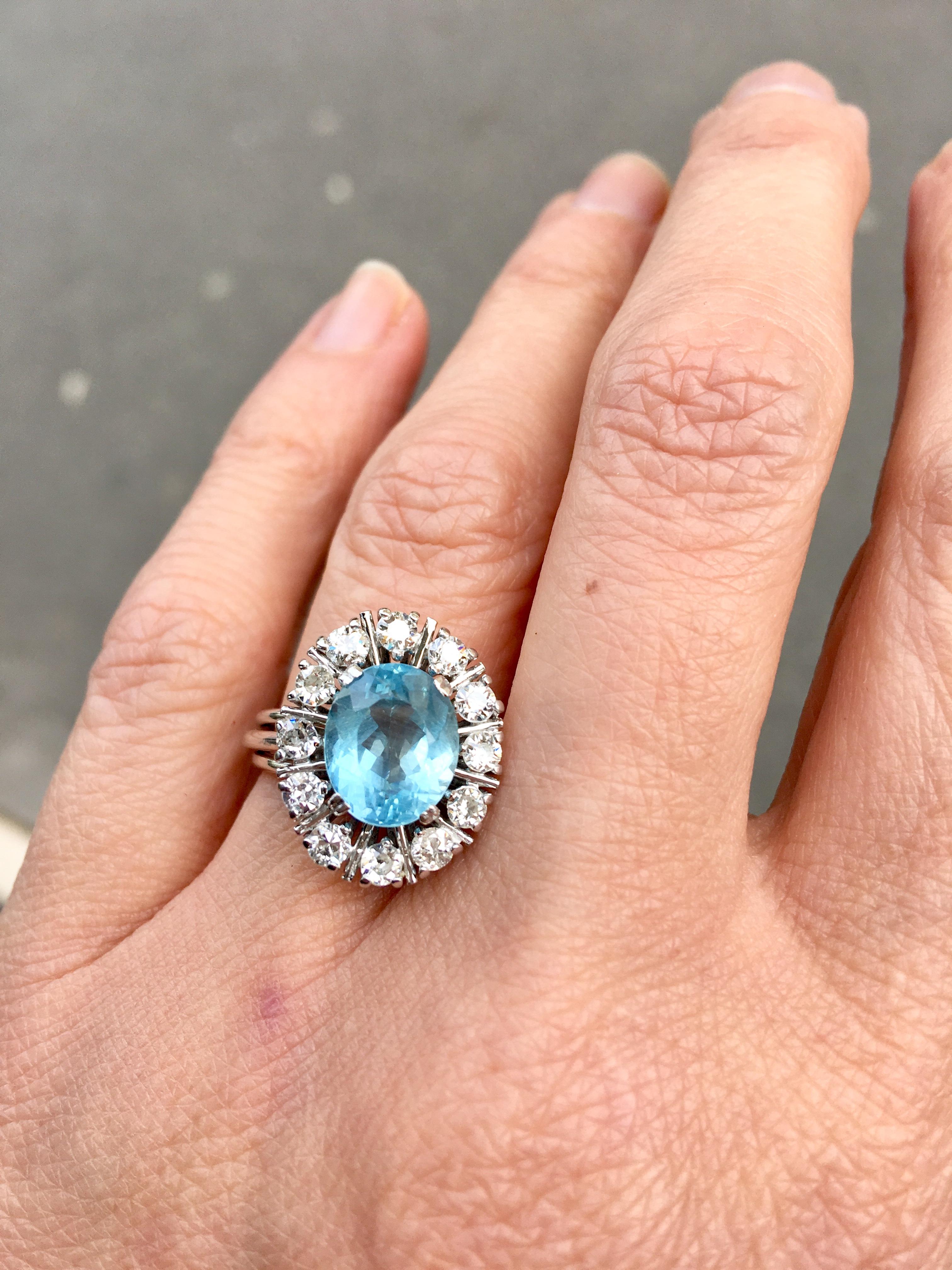 1970’s Daisy shape 2,85 carats Brazilian aquamarine and diamonds cluster engagement ring !

The beautiful Aquamarine is 2.85 carats surrounded by a halo of 12 brilliant old cut Diamonds making a grand total of 0.60ct of Diamonds. 
Aquamarine